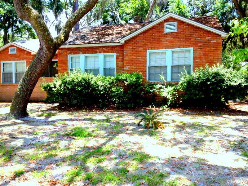 PICTURESQUE HOME in POPULAR COVE SETTING maintains much of its ORIGINAL and VINTAGE CHARM. INTERIOR FEATURES include some HARDWOOD and TERAZZO FLOORING, A WINDOW SEAT in a FRONT-FACING bedroom, and PERIOD INTERIOR DOORS. Formal dining and living spaces and a LARGE ENTRY HALL with CHANDELIER are at the front of the home.  The bedrooms are designed in a SPLIT FLOOR PLAN; GREAT FAMILY SPACES include a LARGE FAMILY ROOM. The OPEN kitchen is equipped with a GAS STOVE, oak cabinetry, and a BREAKFAST BAR. These GENEROUS SPACES lead to the REAR PATIO and SHADE-FILLED YARD.  The LARGE LOT features a DOUBLE CARPORT, and the FENCE has a GATE that can be accessed by the CONVENIENT SIDE ALLEYWAY. Curb appeal, SPACE, and personality all dressed up in BRICK define this DELIGHTFUL COVE SETTING.