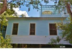 Hidden in a grove of sand oaks and slash pines, this delightful ''Cracker Chic'' cottage provide the privacy and solitude of being surrounded by the forest and yet is only 1,000 feet from the beautiful sugar white sands for which the area beaches are famous. Located in quaint community of Magnolia Cottages By The Sea, one of the more desirable beach destinations on 30A, the cottage is well appointed with Kohler fixtures, hardwoods in all the living & bedrooms area and tile in all baths. Stylish glazed, bead board cabinetry, sleek black appliances and granite counter tops give the kitchen a sophisticated feel while energy efficient windows and doors, hardiplank siding and a galvalume tin roof keep worries and maintenance to a minimum. Designed with family in mind, this well decorated