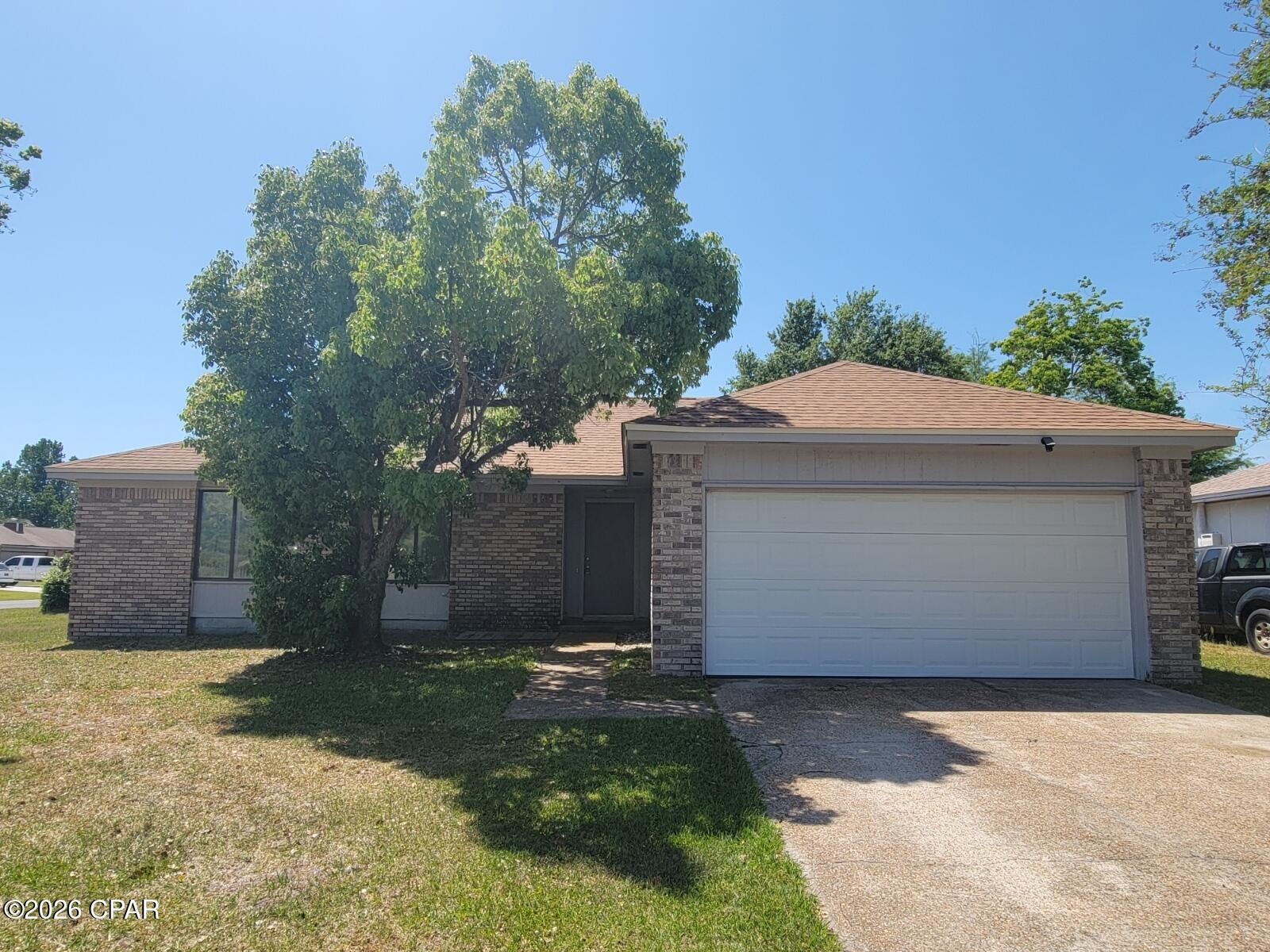 Nice 3 bedroom, 2 bath home with oversized garage. Spacious living room, and also has a formal dining area off the kitchen. New plank and carpet flooring was installed in 2020. Galley style kitchen equipped with refrigerator, range, and dishwasher. Master bedroom has walk-in closet. Fireplace is not operational. Located close to Mosley High School. Lynn Haven is a few miles away for shopping, restaurants, and other local businesses.  Schedule a tour today.
