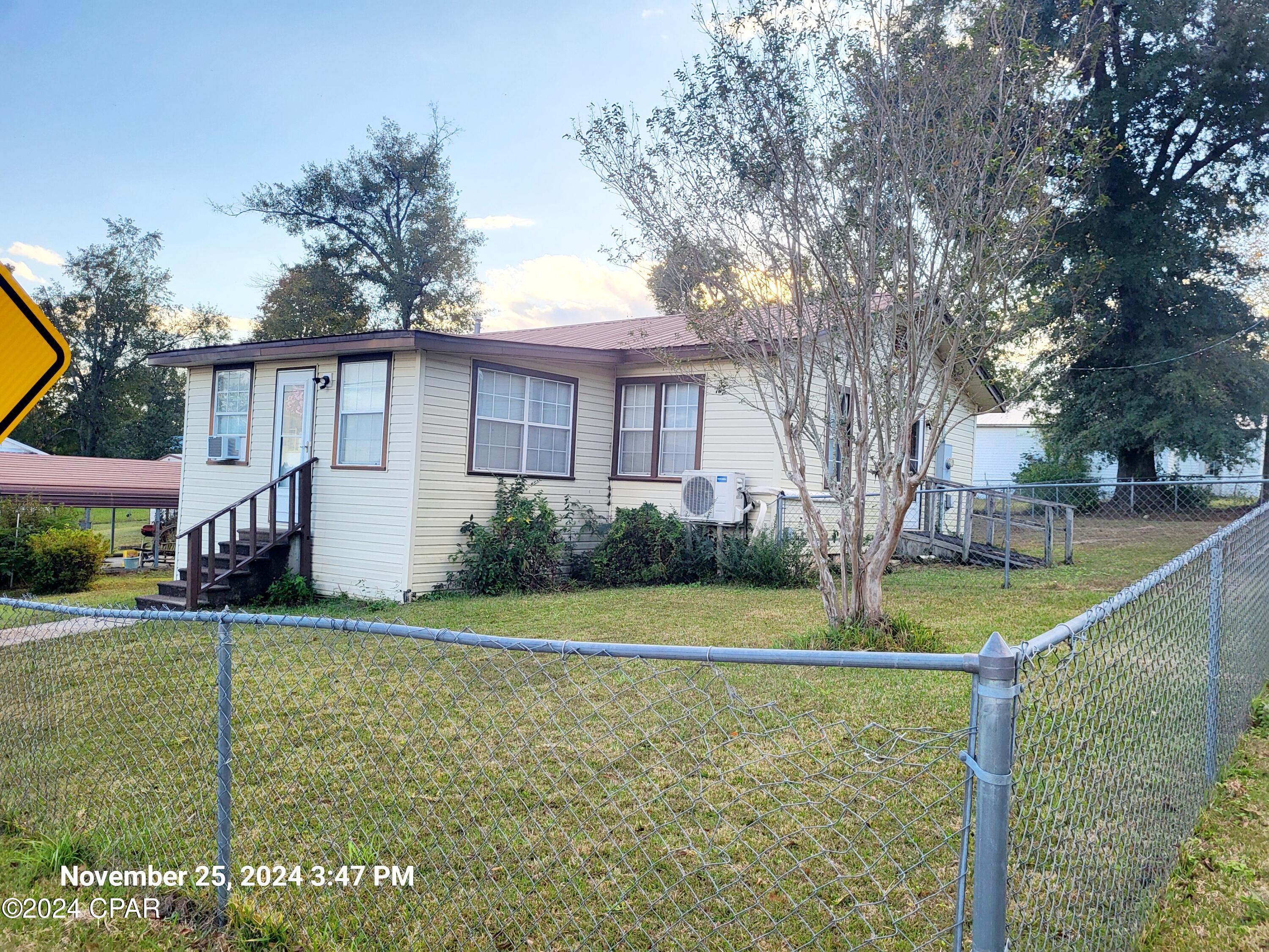 Check out this cute home in Marianna!  This home is close to town, with all the charm of Downtown Marianna.  This home has a large Living and Dining area with an extra living space in the Florida Room that is an enclosed Porch.  3rd Bedroom converted to Laundry Room with room for storage. There are window units in the bedroom and sunroom if you need, but the newer Split Unit is great for heating and cooling the whole house. Need a fenced yard? You've got it!  This 2 bedroom was once a 3 bedroom.  Now it is a 2 bedroom with a laundry room with plenty of storage and closet space.  There is a carport and storage building that will stay with the property.  Room sizes will  need to be verified ,  This home is move in ready.