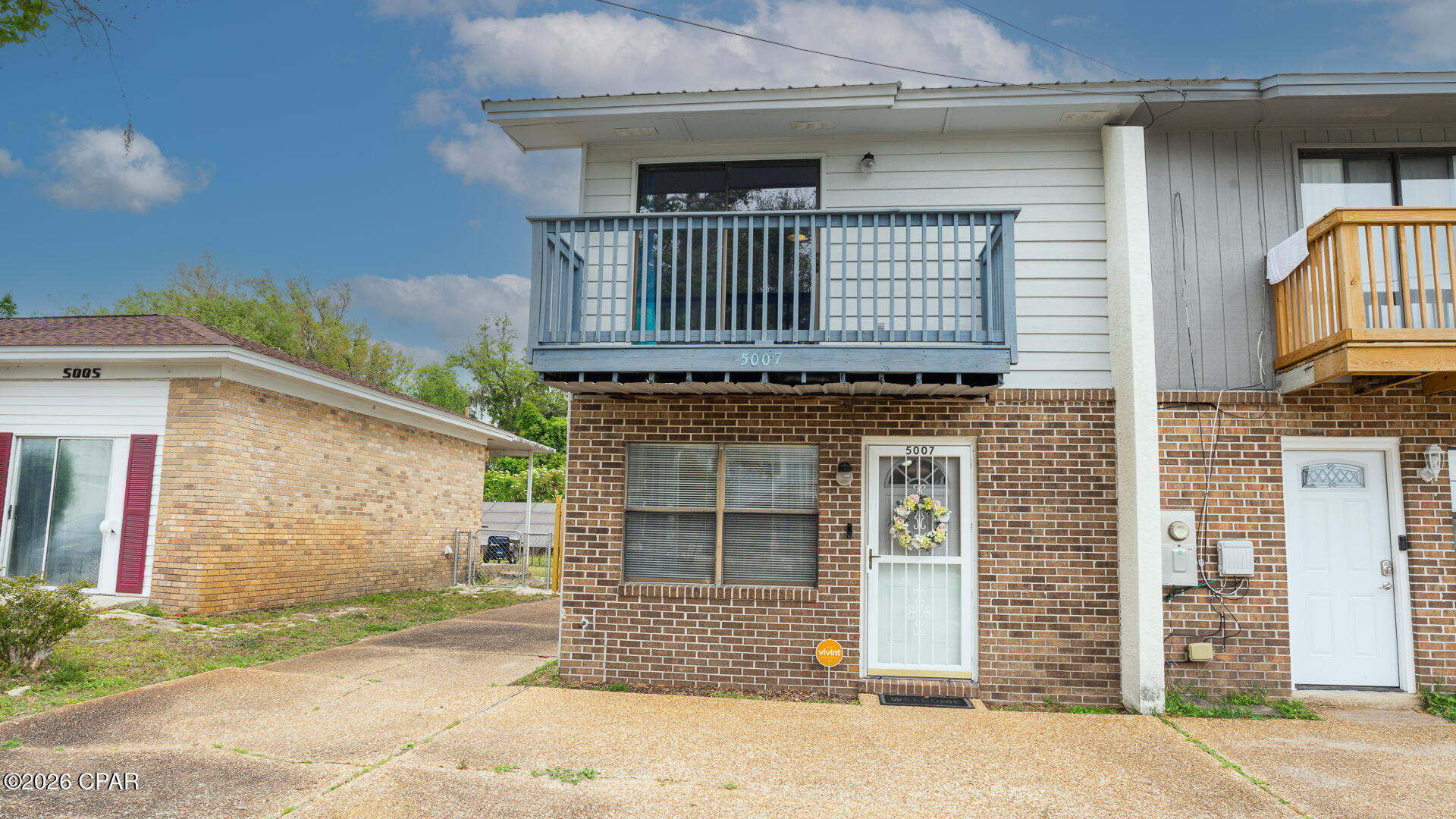 Close to Tyndall this Amazing townhome is 2 BR/2.5 BA end unit and comes with extra driveway space that goes to detached 2 car garage, large U-shaped lot with privacy fence in back yard and no HOA fees.  Great for primary home or rental investment as a short- or long-term rental.  Living room, kitchen and dining area, plus the laundry room and a half bath on first floor. The kitchen is updated with stainless steel appliances, granite countertops, tile backsplash, sliding door to walk out to nicely landscaped back yard.  Tile flooring throughout the downstairs. Upstairs, you will find two large bedrooms, each with private full bathrooms.  Master suite features a balcony with a beautiful water view of Pitts Bayou.  Furniture does convey. Conveniently located near Tyndall Air Force Base, Mexico Beach, shopping, schools, parks, boat ramps, and much more! Dimensions are approximate.
