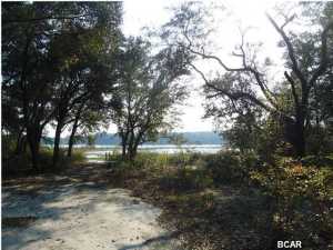 OVER 10 ACRES PENINSULA OF LAND FRONTING WAGES POND.THIS PARCEL HAS HUGE OAK TREES WITH SPANISH MOSS MAKING A SHADED CANOPY OVER THE RUSTIC CABIN.VALUE IS IN THE LAND.THIS IS A QUIET AND PEACEFUL GETAWAY AND IS ADJACENT TO THE NORTHWEST FLORIDA WATER MANAGEMENT DISTRICT ENTRY FOR MILES, GREAT FOR HORSEBACK RIDING AND HIKING. LOOKING FOR PRIVACY VEIW THIS PROPERTY.