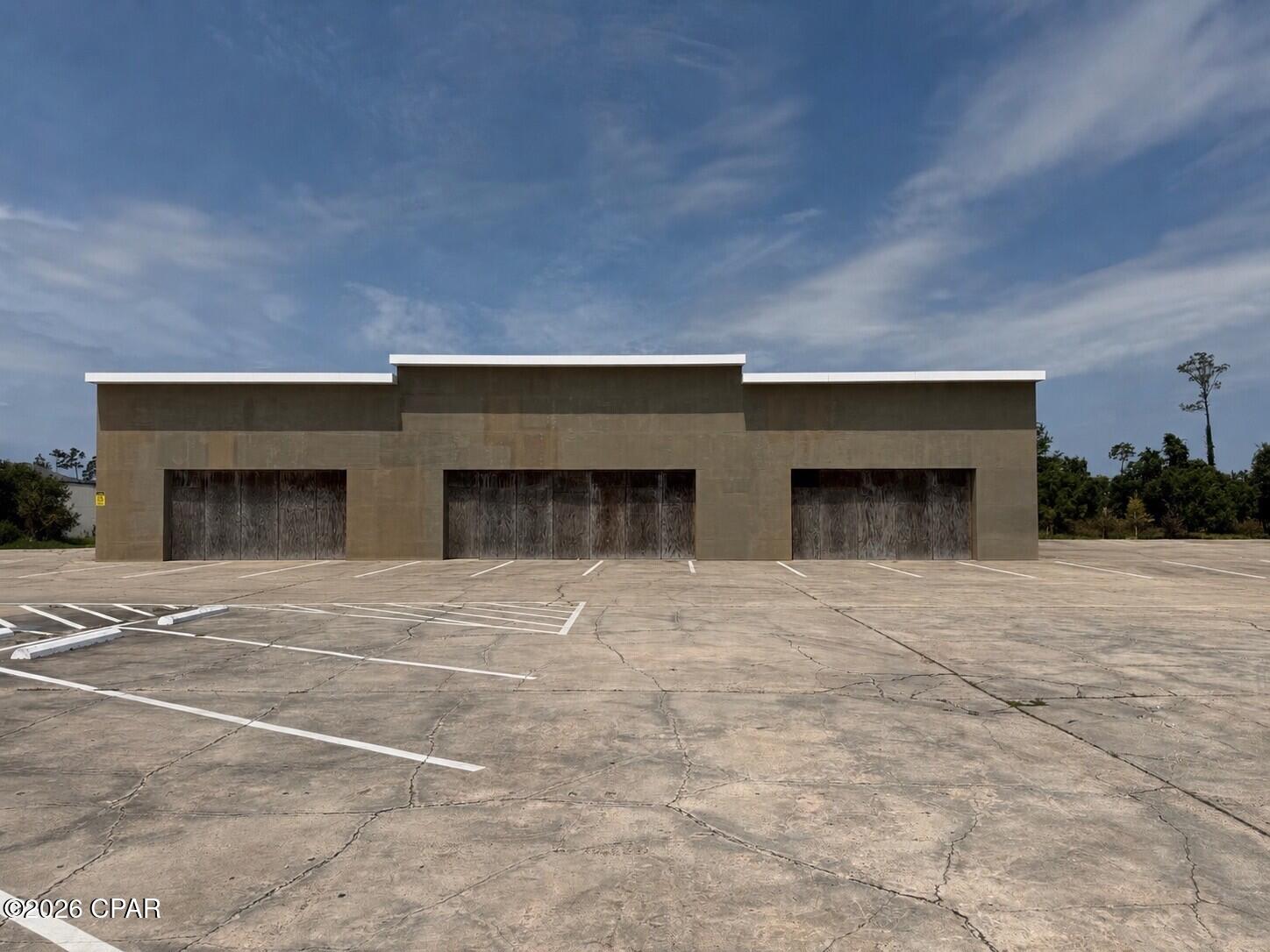 10,000 SF open warehouse with 14' ceilings that can be built out to suit your needs. Lease rate is for building with sheetrock walls, spray foam ceiling, bay lights, one bay door and two bathrooms. Front exterior of building will be finished  to match the space opposite of this one at location (photo included with listing photos). This is a NNN lease.