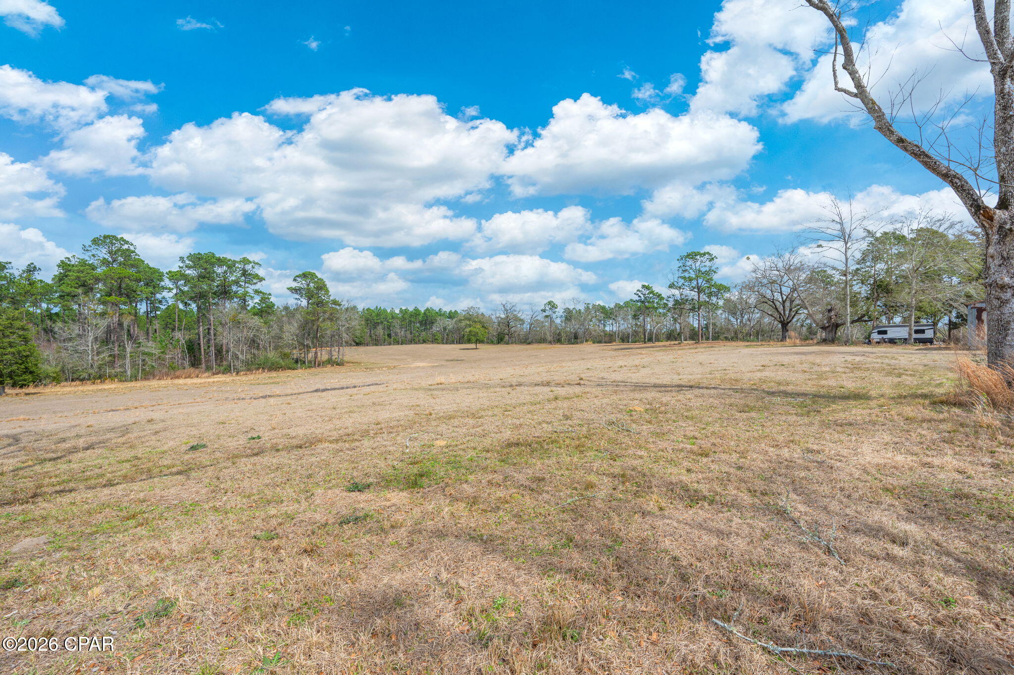 Discover the perfect opportunity to build your dream homestead, mini-farm, or private country retreat on this beautiful 16  +/- acre parcel. Mostly cleared and partially fenced around portions of the perimeter, this versatile property offers a blend of open space, mature pecan trees, and peaceful rural surroundings.

The land provides an excellent foundation for a custom home, agricultural use, livestock, equestrian pursuits, or recreational enjoyment. With much of the property already cleared, buyers can save both time and expense when preparing for future development while still enjoying the flexibility to create a property tailored to their needs.

An older home is located on the property and is being offered with no contributory value. The structure does not have a usable well or septic system and may be suitable for removal, renovation, storage, or other uses as determined by the buyer.

Enjoy the privacy and tranquility of country living while remaining conveniently located within driving distance of the world-famous Emerald Coast beaches. Spend your days enjoying sugar-white sand beaches, emerald-green waters, shopping, dining, fishing, and entertainment, then return home to the peace and quiet of your own private acreage.

For buyers seeking additional land and improvements, an adjoining 24±/- acre parcel is also available for purchase. The neighboring property features a 2024 upgraded manufactured home, mature pecan orchard, in-ground heated swimming pool, barn with tack room. Combined, the two parcels offer the rare opportunity to own approximately 40±/- contiguous acres, creating an exceptional estate, equestrian property, family compound, or agricultural operation.

Acreage is subject to final survey and verification. Schedule your private showing today for additional information and to explore the possibilities this unique property has to offer.
