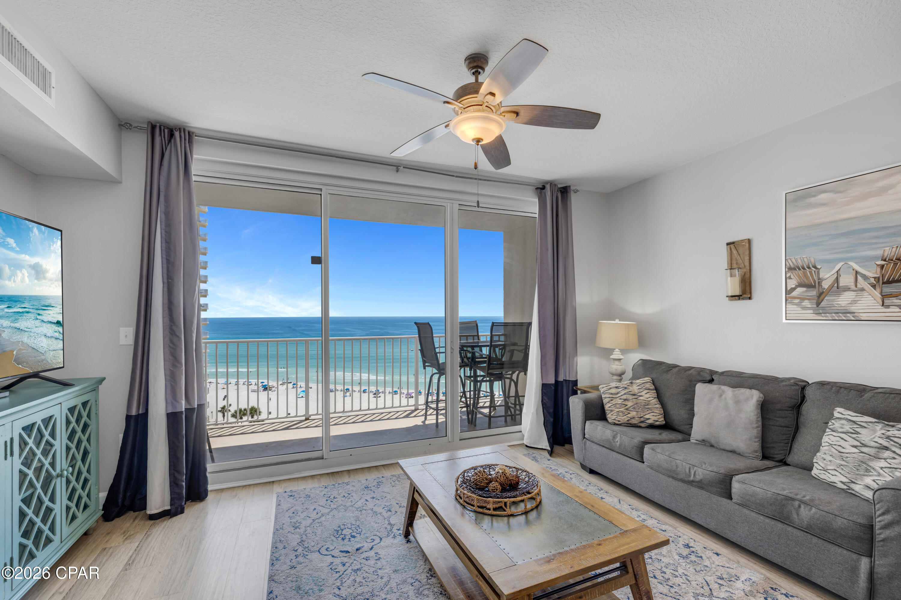 SAME-FLOOR PARKING | CENTER-STACK POSITION | WEST-FACING GULF VIEWS

Shores of Panama 1013 stands out for reasons that go beyond the typical beachfront condo checklist. Positioned in the center stack of the building, this Type-C floor plan offers a more balanced placement within the tower along with the convenience of a deeded parking space on the same level.

One of the most practical advantages of this location is the covered access from the adjacent parking area, allowing you to move from your vehicle to your front door with added protection from the weather. It is a feature owners and guests appreciate right away, especially on arrival days, grocery runs, and beach weekends.

This floor plan includes 2 bedrooms, 2 full bathrooms, in-unit laundry, and a west-facing balcony with views overlooking the lagoon-style pool and the Gulf beyond. From the moment you step inside, you will notice the thoughtful updates and clean presentation that help set this condo apart.
Luxury floating LVP flooring runs throughout the unit and pairs nicely with freshly painted walls and tasteful furnishings. The living room and bedroom both include privacy curtains, and the kitchen is equipped with stainless steel appliances. Flat-screen TVs, a front-load washer and dryer, and a fully furnished turn-key setup add to the overall convenience and appeal. Major system updates include the HVAC and water heater, both replaced in 2019. 

The balcony offers more than 30 feet of outdoor space, creating a comfortable place to take in west-facing views of the resort pool, tropical grounds, and turquoise Gulf waters. It is the kind of perspective that reinforces why the center section of Shores of Panama continues to draw attention from buyers looking for a strong blend of view, layout, and convenience. 
 
Shores of Panama Resort features the largest Gulf-front lagoon pool in Panama City Beach. The zero-entry tropical pool includes palm-lined islands, fountains, and a spacious hot tub along the resort's private beachfront access. Additional amenities include an indoor heated pool and hot tub, a 24-hour fitness center, and a seasonal poolside Tiki bar.  

Located in the heart of Panama City Beach, Shores of Panama places dining, shopping, and entertainment nearby. Pineapple Willy's is adjacent to the resort, while Laketown Wharf directly across the street offers several dining, retail, and entertainment options, including Wharf Seafood Buffet, The Candymaker Ice Cream Shop, PCB Pizza, In Cahoots, The Press, The Bun Lab, 810 Billiards & Bowling, salon services, and more. Panama City Beach has also welcomed several newer attractions and entertainment venues, including Dolly Parton's Pirates Voyage Dinner & Show, Topgolf, McGuire's Irish Pub, and Tootsie's Orchid Lounge. 

HOA dues are $3,108.96 per quarter. All information and HOA fees are deemed accurate but should be verified by buyers if important.