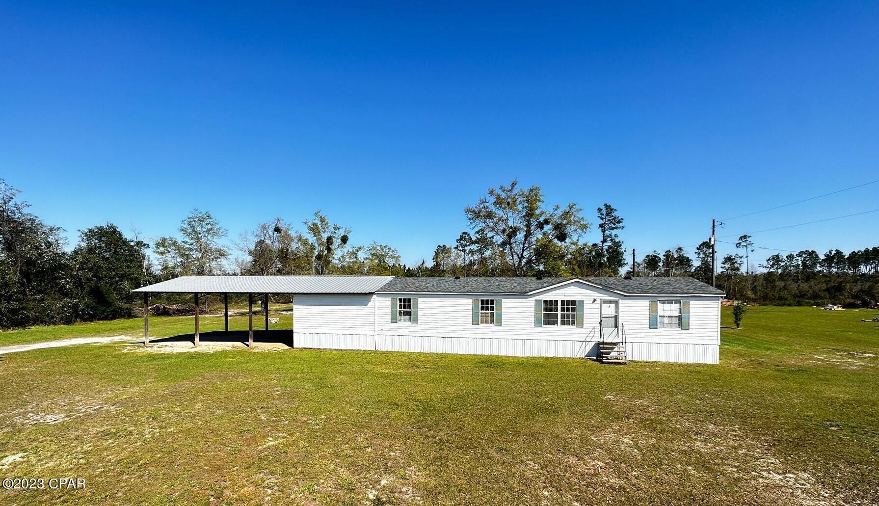 Big price improvement!! Beautiful, spacious affordability are key words for this home! The spacious floor plan has a large living room with a brick wood burning fireplace and split bedrooms. A bright, eat-in kitchen with tile backsplash has a sliding glass door that leads to a fully screened back porch area that makes for a great place to entertain and have room to spread out! The large acre and one half lot has lots of room for kids to play! The attached 24x36 pole barn with storage and lights has plenty of room for parking, tools and big boy toys! This parking area leads into the home from another nice raised porch and into the laundry/mud room near the walkin pantry storage and to the kitchen with LOTS of cabinets! New roof in 2018 & diesel generator for the house, makes this a MUST SEE