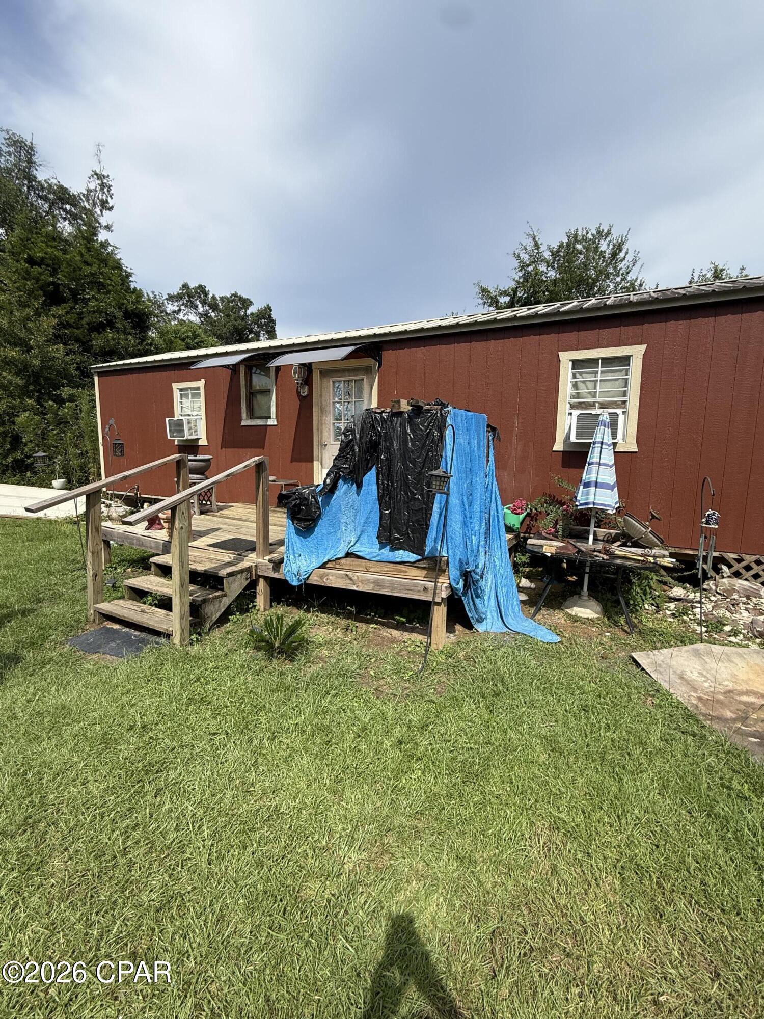 1 bedroom/1/bath tiny home (less than 400 sq ft) sitting on 2 private, wooded acres with a deeded 20 ft wide driveway easement. There is a 200 amp electrical service pole along with a private well and septic tank hooked up to the home. There is an old mobile home on the property, which is of little value but is the recorded, assessed home on the property appraiser website. The tiny home is insulated but unfinished (no paneling) on the inside. No appliances or AC window units convey with the home.
