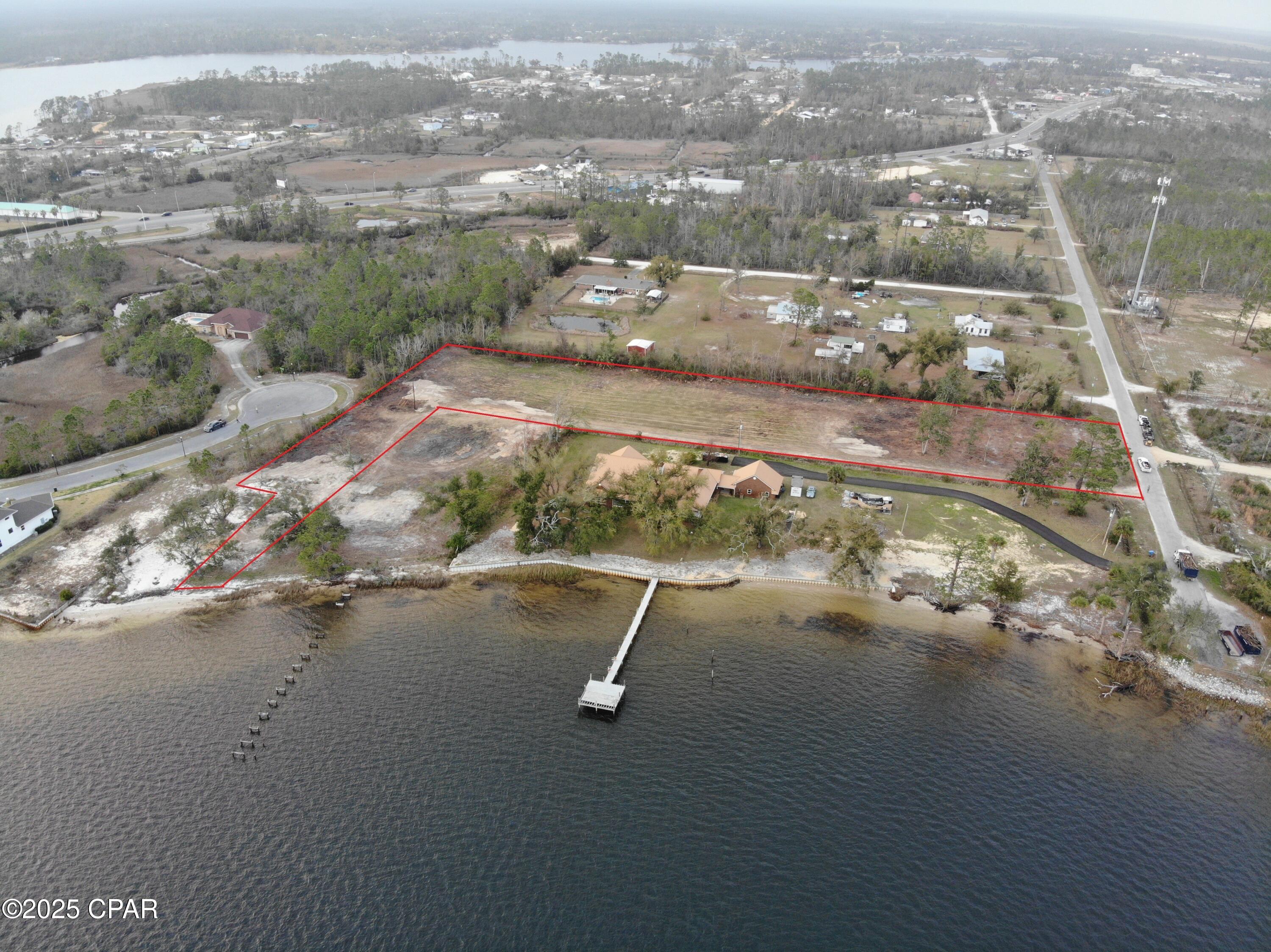 Waterfront Development Opportunity with Entitlements in Place. Bay Breeze Shores is nestled along North Bay in the City of Lynn Haven. This waterfront property offers a rare opportunity for visionary developers and investors. With panoramic water views and wildlife to observe, promising a lifestyle of tranquility and privacy, making it an ideal site for creating an exclusive multifamily community. Conveniently located half a mile to Highway 77 for easy access to Downtown City of Lynn Haven's Restaurants and friendly parks, as well as 15 miles to Northwest Florida Beaches International Airport. Ride golf cart 1 mile to Leslie Porter Wayside Park byway of Bailey Bridge Fishing Pier, to enjoy a Beach-Like feel or bask in the beautiful Florida Sun. Amenities are endless. Dock & Seawall permits in place giving this community direct access to the Gulf. This property's unique location makes it suitable for various types of developments. Whether you envision an upscale residential community with waterfront access or a tranquil rental resort that attracts visitors seeking relaxation to enjoy the natural beauty Florida has to offer. Currently Zoned High Density Residential with an Approved Development Order for 38 units on 2.92 acres. There is an additional .82 acre Out-parcel available for expansion. Entire Property is High and Dry.