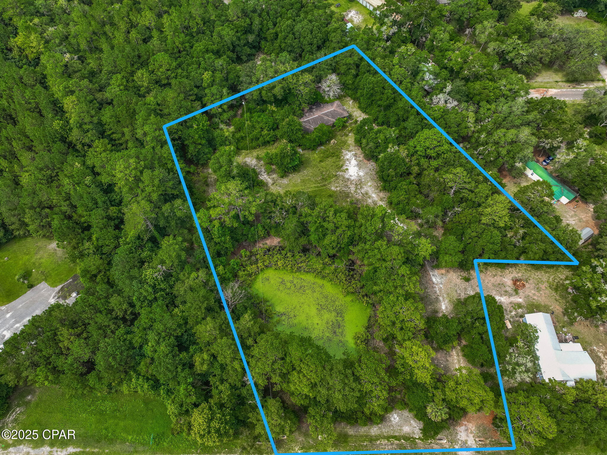 Under contract. Seller will accept a back up offer.Located just north of intersection of Hwy 90 and Hwy 81, this 4.1-acre parcel offers outstanding potential for private home location, commercial or residential development. Zoned Urban Mixed Use, the property allows for a wide range of possibilities including townhomes, retail, office space, or mixed residential and commercial use. While there is an existing 3-bedroom, 2-bath home on the property, no value has been attributed to it due to its condition and need for a full renovation. The land itself is the true assetâ'featuring approximately 210 feet of road frontage and a beautiful spring-fed pond that adds natural character and potential aesthetic value for future development. Whether you're looking to live on a large privste lot, develop townhomes, start a commercial project, or hold for investment, this property offers location, flexibility, and opportunity.