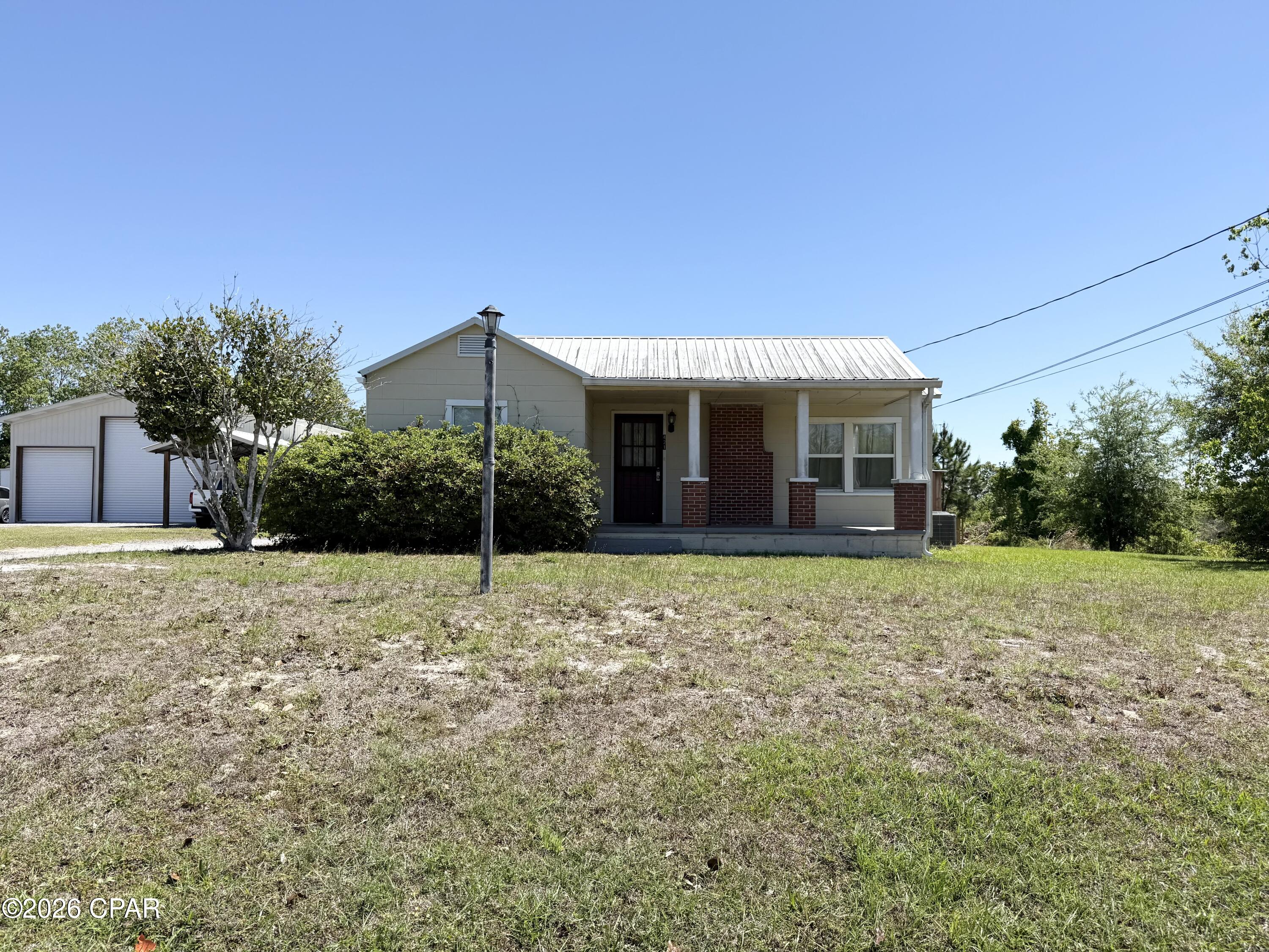 CURRENTLY UNDER CONTRACT, SELLER WILL CONSIDER BACKUP OFFERS - Charming Florida cottage situated on over one-third of an acre, offering the perfect blend of character, functionality, and outdoor space. This inviting 3-bedroom, 2-full-bath home features beautiful wood floors, granite countertops in the kitchen, and a bright, versatile sunroom that can easily serve as a dining room, home office, playroom, or additional living space.

The home also offers the convenience of an inside laundry area and plenty of storage throughout. Outside, you'll find a separate garage with storage and workshop space, ideal for hobbies, tools, or extra equipment, along with a cozy firepit area perfect for relaxing evenings and entertaining guests.

The large open backyard provides plenty of room for pets, play, gardening, or future outdoor additions. Recent updates include a metal roof (2017), crawl space encapsulation, and new shed siding, adding value and peace of mind for the next owner.

Whether you're searching for a great starter home, downsizing option, or investment property, this charming cottage offers endless potential in a wonderful setting.
