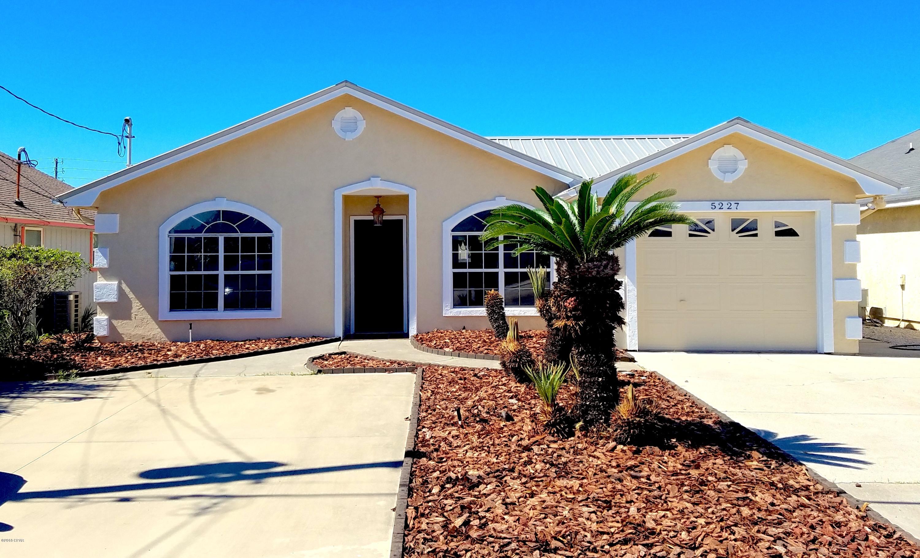 Immaculate two bedroom, two bathroom home just STEPS AWAY FROM THE WORLD'S MOST BEAUTIFUL BEACHES!!  Home features tile throughout, large windows that are dressed with attractive plantation shutters, kitchen has stainless steel appliances and a pass through window into the dining area, making entertaining a breeze.  Patio overlooks a privacy fenced backyard and low maintenance landscaping.  Make arrangements to see this home before someone else beats you to it!