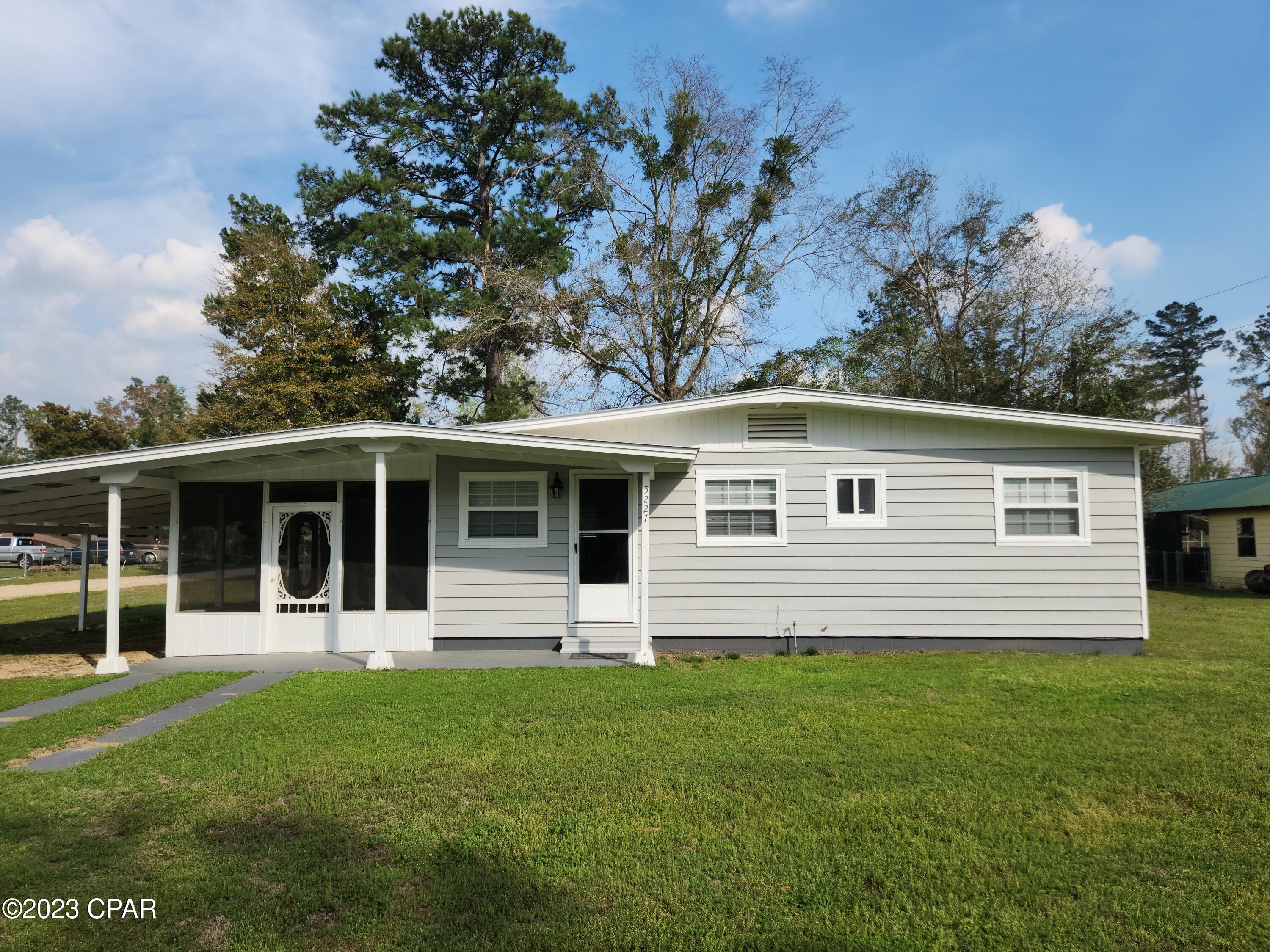 This 2 bed 1 bath country home on a corner lot is nestled in a small community right along the Chipola River. With a screened in porch and room to expand this house would make a great starter home or even a quiet relaxing vacation home for an avid fisherman. There is a  boat ramp used only by the residents of the neighborhood and a public boat ramp close by.  The inside features newer stainless steel appliances with tile backsplash and beautiful real wood floors you have to see.  The utility room is over sized for additional storage and includes a top of the line water filtration system.  The carport is plenty long enough to store a boat and there is a small metal utility building out back if you need more storage space. The combination of the river being a stone's throw away and the beauty of the home makes it a hard to beat combination for under $200k.
