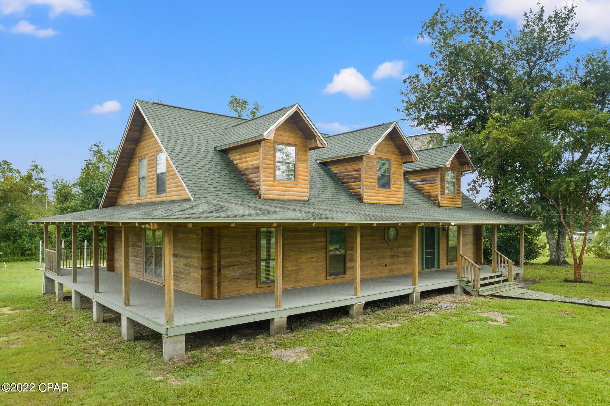 CURRENTLY UNDER CONTRACT.  SELLER WILL CONSIDER BACK UP OFFERS.  If you're looking for a spacious home on a nice (1.2 acres) property, you've found it!  The log home features a large wrap around porch to enjoy the outdoors. The backyard has a covered deck and large, sparkling pool.  There is a 40' x 22' RV pad that has water, sewer, and a 50 amp hookup.  This home features 3 bedrooms as well as a 4th room that can be used as an office, craft room, or add a closet and it's another bedroom.  The family room has 2 story ceilings and a wood burning fireplace.  The unique kitchen features copper countertops and lots of storage.  The large master bedroom opens into a spacious master bath with jacuzzi tub, separate shower, and two pedestal sinks.  Large master closet is cedar lined.