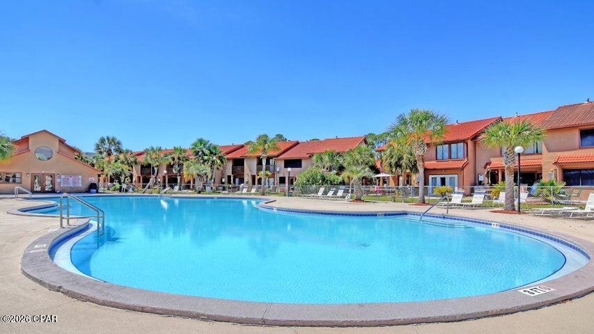 Grab your sunscreen and towel and take a stroll down to the warm white sands and cool blue waters of Panama City Beach! This updated townhome in Gulf Highlands Beach Resort is fully furnished and ready for your family! Park directly in front of your unit in the two dedicated parking spots. No elevators to maneuver with groceries or beach toys! The large, open floor plan, full-sized kitchen with an oversized breakfast bar and abundant cabinet and counter space makes this the ideal place for friends and families to gather. The living area features sliding glass doors which lead to a lovely patio area with a view down the length of the canal! Sit on your deck and feed the turtles and watch the herons fish. Gulf Highlands offers an array of amenities including 11 swimming pools (5 heated), 3 tennis courts, pickleball, fitness center, mini-golf, 2 playgrounds, shuffleboard, conference center, and a private clubhouse featuring restaurant and pool overlooking the Gulf. Numerous entertainment options are available within walking or golf cart distance. This secure, golf cart-friendly resort offers an ideal environment for short-term renters and full-time residents alike. This unit has never been on a rental program but has a projected annual rental income of over 40K. The low HOA fees cover trash disposal, internet, landscaping, pool servicing, termite & pest control and upkeep of all amenities.  Age, Sq Ft, and dimensions approximate.