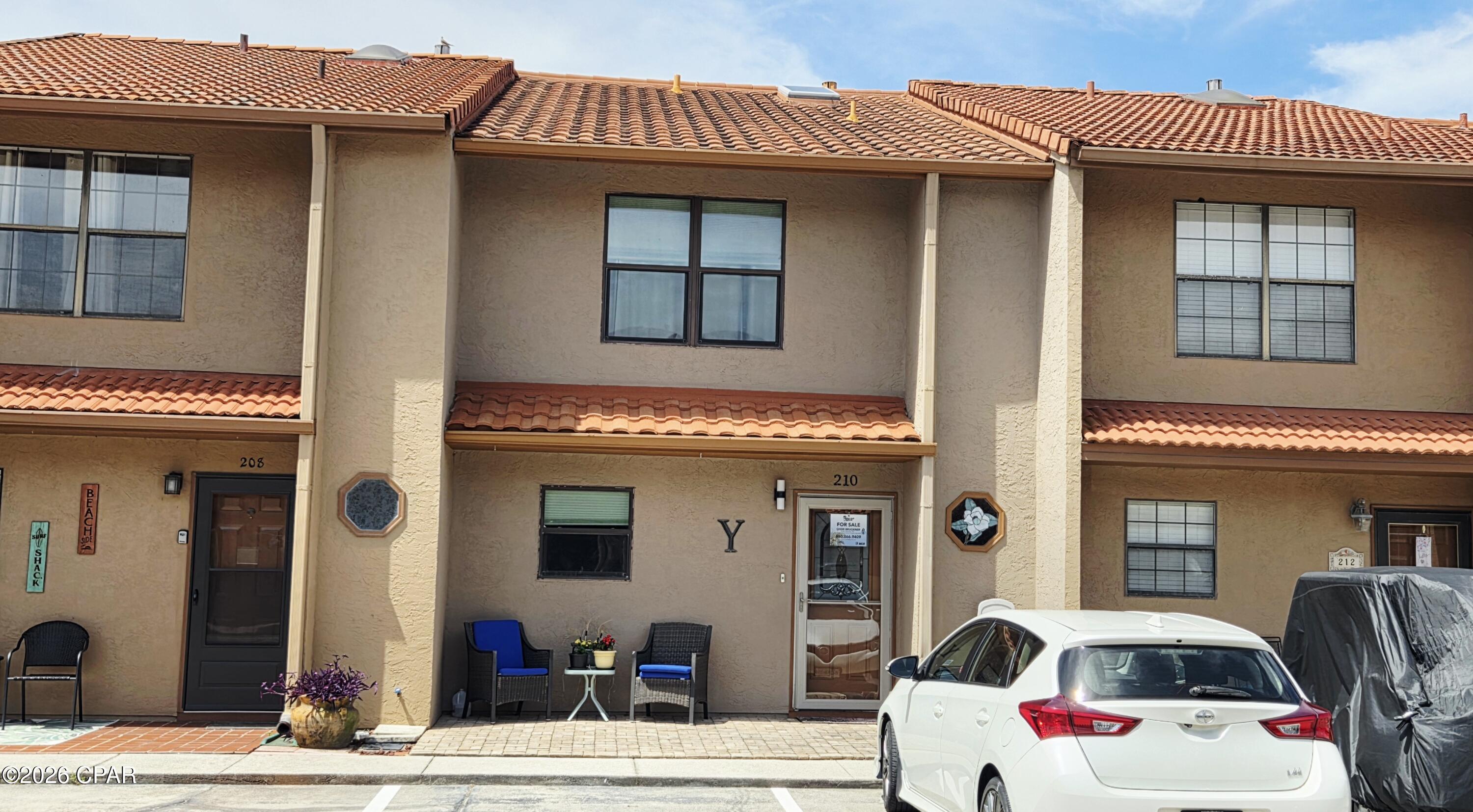 Grab your sunscreen and towel and take a stroll down to the warm white sands and cool blue waters of Panama City Beach! This updated townhome in Gulf Highlands Beach Resort is fully furnished and ready for your family! Park directly in front of your unit in the two dedicated parking spots. No elevators to maneuver with groceries or beach toys! The large, open floor plan, full-sized kitchen with an oversized breakfast bar and abundant cabinet and counter space makes this the ideal place for friends and families to gather. The living area features sliding glass doors which lead to a lovely patio area with a view down the length of the canal! Sit on your deck and feed the turtles and watch the herons fish. Gulf Highlands offers an array of amenities including 11 swimming pools (5 heated), 3 tennis courts, pickleball, fitness center, mini-golf, 2 playgrounds, shuffleboard, conference center, and a private clubhouse featuring restaurant and pool overlooking the Gulf. Numerous entertainment options are available within walking or golf cart distance. This secure, golf cart-friendly resort offers an ideal environment for short-term renters and full-time residents alike. This unit has never been on a rental program but has a projected annual rental income of over 40K. The low HOA fees cover trash disposal, internet, landscaping, pool servicing, termite & pest control and upkeep of all amenities.  Age, Sq Ft, and dimensions approximate.
