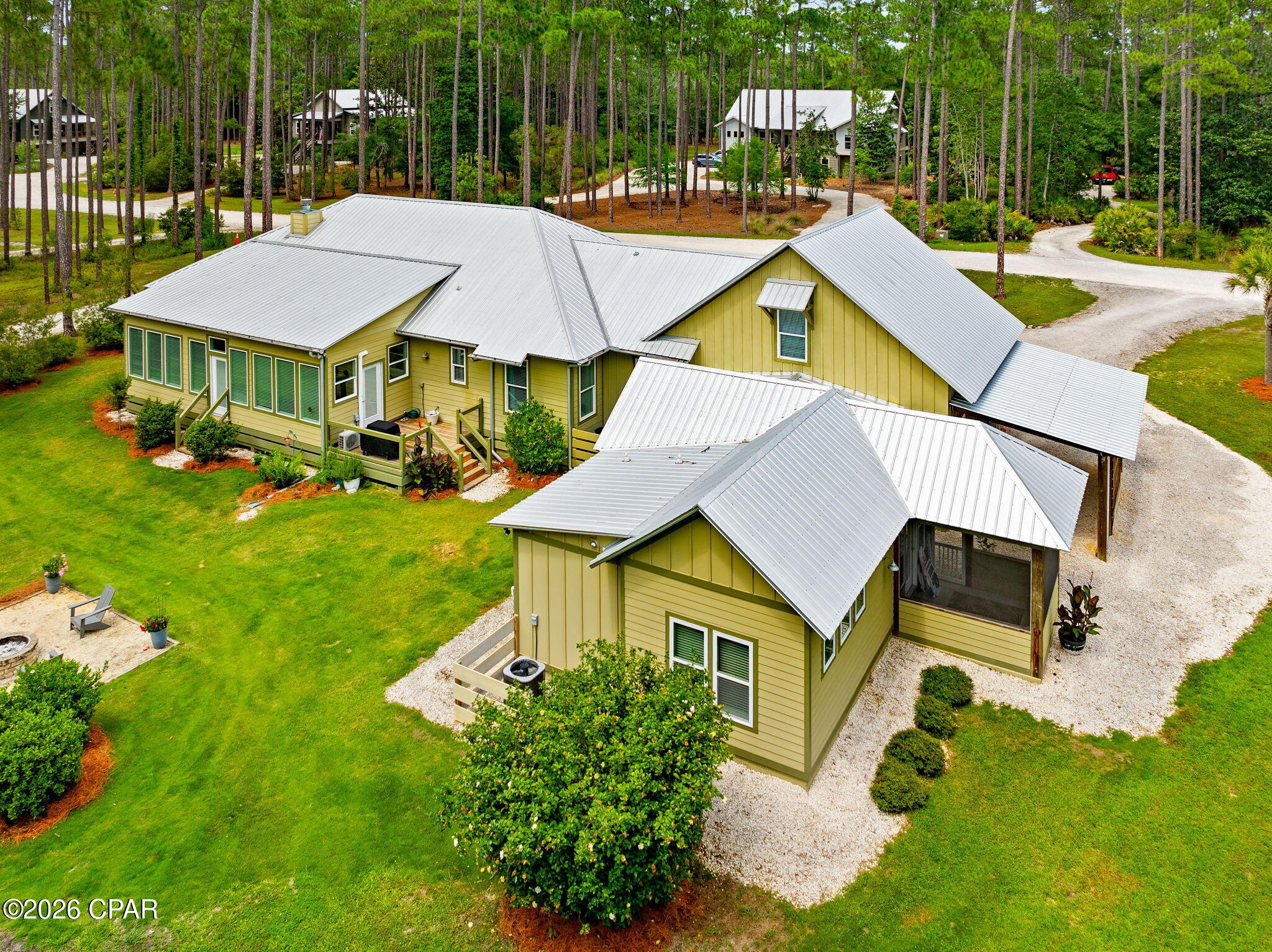 GENERATIONAL LIVING!! 6408 River Bluff Trail is a custom built home that offers elegant single-story living in the prominent community of RiverCamps on Crooked Creek. This home offers a spacious 3,384 square feet of heated and cooled living space. Included in this square footage is a guest house for multi generational living, a bonus room above garage that includes a half bath, and a four Seasons room that is perfect for watching wildlife.

The main living space includes 2,079 square feet. Ceramic Tile floors are found throughout main living area, kitchen, bedrooms, and bathrooms. Bullnose-Edge Quartz countertops, and oversized kitchen island are found in the modern kitchen. A gorgeous wood burning fireplace with 100 year old hard pine mantel sits at the focus of the living room.
This home boasts 8 foot entry and closet doors in the main living space. And features 10 foot ceilings throughout with cathedral ceiling in living room and kitchen. It also offers oversized two car garage with 10 foot ceilings and 8 foot entry doors. As well as 220 power in garage. There are two master suites in main living space. The primary master bathroom features a claw foot tub, and curb less walk in shower. A new HVAC was installed in main house in December 2025.
The Four Seasons Room is adorned with full wall windows that are perfect for watching the neighborhood wildlife. It also features LVP flooring, and a Mini Split HVAC system.This home truly provides a rare opportunity with the inclusion of the guest house. The guest house which was built in 2022 features a master bedroom, and master bathroom with a curb less walk in shower. It also includes a living area and kitchen. Other key features include a dedicated car port, and screened in porch.
This homesite offers usable outdoor space that includes a fire pit, and an outdoor shower.
RiverCamps on Crooked Creek is a Certified Nature Preserve Community. The community offers resort style amenities. Amenities include gated access, a future river house, newly built community pool, boardwalks and trails, kayak and paddle boards, fitness center currently being built, as well as community boat ramp, and boat storage for residents. The home is within walking distance to additional boat dock on crooked creek.
RiverCamps is in close proximity to many local businesses's. It is only 10 miles from Pier Park and the famous white sandy beaches. It's also 2 and a half miles from NW Florida Beaches International Airport. 3 and a half miles from Publix, to be opening soon. And approximately 5 miles to new hospital, to be opening in 2028. Furnishings are negotiable. Measurements approximate. All information is deemed reliable, but not guaranteed. Buyer to verify if important.