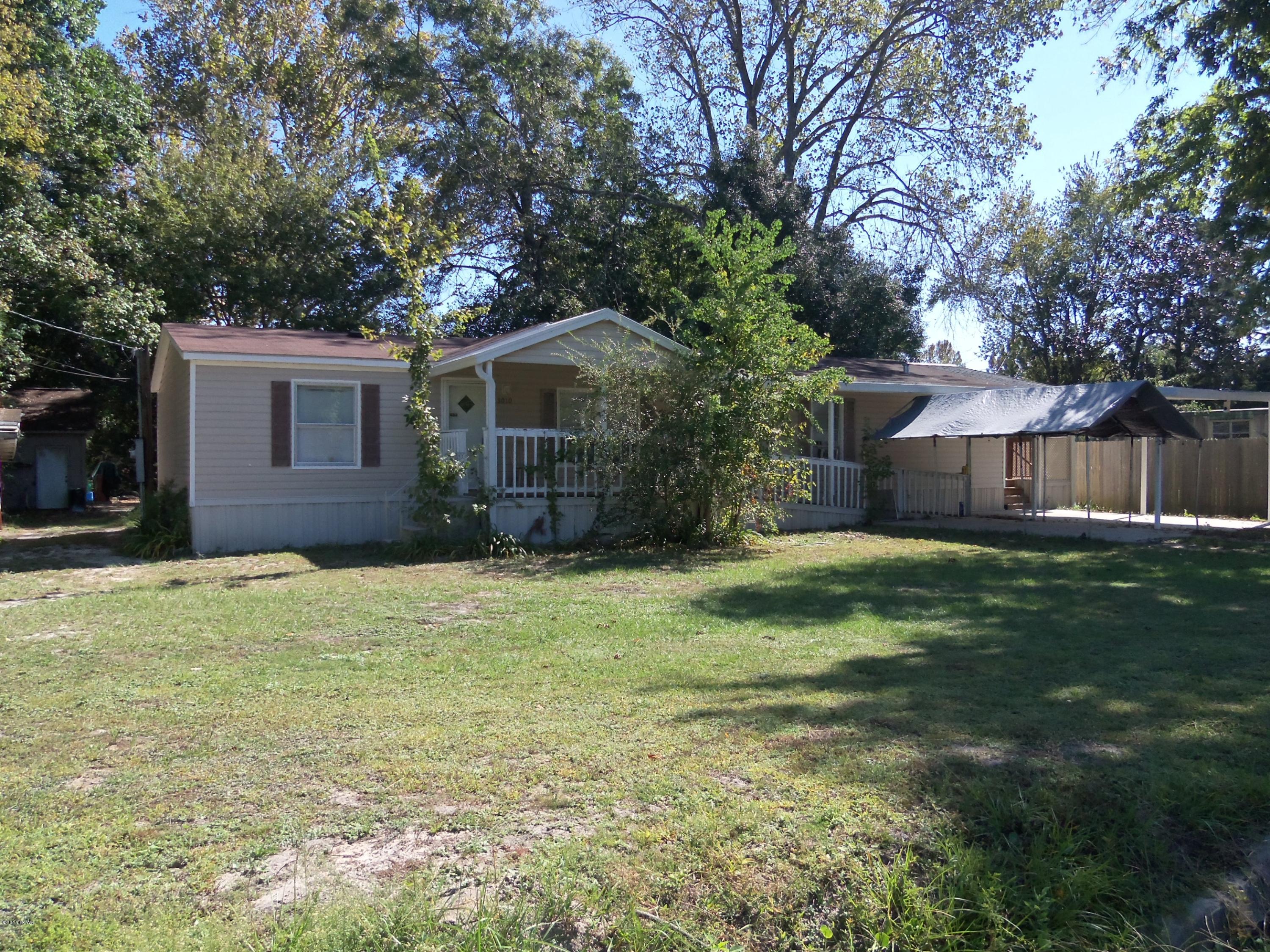 Location, location! This very well maintained home is located right in the heart of town, but the large shaded lot provides a nice country feel. Convenient to everything, this lovely 3 bedroom 2 bath home features 2 living areas - family room has a wood burning fireplace, split bedroom plan, large kitchen with lots of cabinets and large pantry, over-sized laundry room. The master bedroom features a nice bath with double vanities, 4' shower and separate garden tub. Tons of storage throughout. For the outdoor living area, there are 3 covered decks (back deck has a built in bench) and a covered walkway from the carport to the house! Great for staying dry on those rainy days! And, that's not all... There's a huge 20x24' shop in the back yard, with easy access from the alley! The shop has 240 volts run to it for welding or heavy shop equipment. (All sizes approximate and taken from public records, buyer to verify any details buyer deems important).