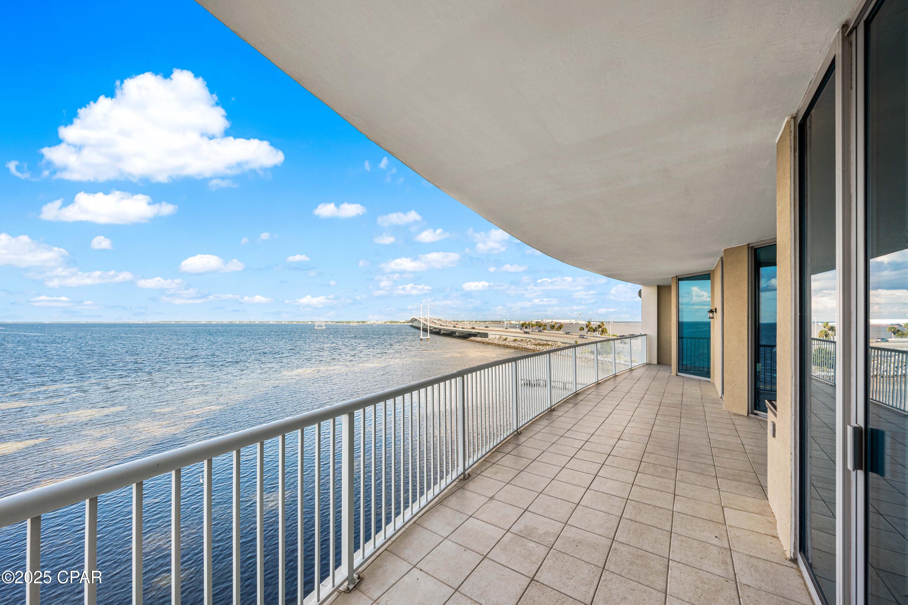 CURRENTLY UNDER CONTRACT, SELLER WILL CONSIDER BACKUP OFFERS. Experience elevated coastal living at Marina Landing Unit 404, a beautifully appointed two-bedroom, two-bath bayfront retreat with sweeping views of St. Andrew's Bay, offered fully furnished with tasteful updates and thoughtful design throughout.  This fourth floor residence is ideally positioned just off the elevator and includes a private storage closet with rare electrical access. 

Enter an open concept living where floor-to-ceiling glass showcases sweeping water views. The renovated kitchen features stone countertops, stainless steel appliances, abundant cabinetry, and a pantry housing the in-unit laundry. Elegant lighting and updated fixtures elevate every corner of the interior, complemented by new LVP flooring and freshly painted walls. 

The living and dining areas center around a cozy fireplace and flow seamlessly onto a massive 500-square-foot covered balcony. Your private outdoor sanctuary, complete with a built-in grill and plenty of space for lounging and entertaining. From here, enjoy unobstructed views, soft bay breezes, and frequent dolphin sightings that make every day feel like a postcard. 

The primary suite offers direct balcony access, room for a king-size bed, and breathtaking water views. Its luxury en-suite bath includes a double vanity, a deep soaker tub, a separate glass-enclosed shower, and a generous walk-in closet. The spacious second bedroom also enjoys bay views, private balcony access, and en-suite bath with updated cabinetry and its own walk-in closet. 

Many amenities include: 
Resort-style bayfront pool 
Well-equipped fitness center
Resident meeting room
Walk-out dock with kayak and paddleboard access Natural walking path along the bayfront 
Adjacent marina offering slips for rent 
Covered, assigned parking (Space #68)

 This residence combines refined finishes, unmatched views, and tranquil surroundings in a well-maintained, upscale community just minutes from beaches, dining, and local attractions. 

Offered furnished with an exclusions list and updates list in the Documents section.