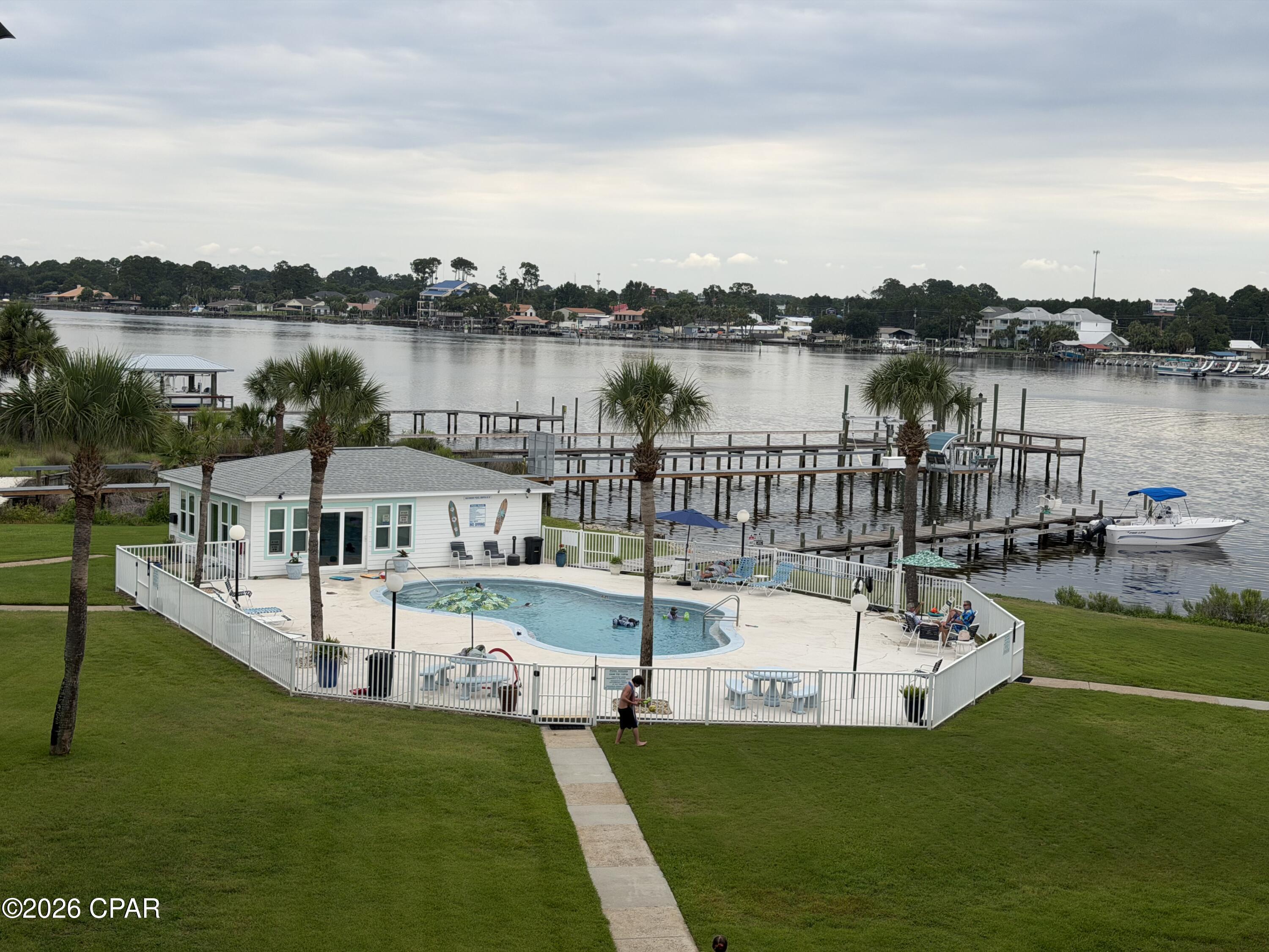 Welcome to Treasure Cove Condominiums on beautiful Grand Lagoon! OWNER IS OFFERING $10,000 Furniture credit to be able to make it your own slice of Paradise. Also, Owner is willing to trade for a single-family home of equal value. This spacious 1-bedroom, 1-bath condo with a loft offers approximately 980 square feet of coastal living in one of Panama City Beach's most desirable waterfront communities. Located on the third floor, this well-maintained unit features soaring ceilings, an open-concept living area, updated finishes, and a private balcony perfect for enjoying lagoon views and Gulf Coast breezes. Featuring Washer and Dryer Hookups for added convenience  Recent improvements include updated bathroom fixtures, kitchen countertops, lighting, ceiling fans, flooring, and sliding glass doors. The versatile loft provides additional sleeping space, a home office, or recreation area. Treasure Cove amenities include a lagoon-front pool, fishing dock, and boat dock access, with convenient proximity to marinas, restaurants, shopping, public beach access, and St. Andrews State Park. Whether you're seeking a primary residence, vacation getaway, or investment property, this turnkey condo offers an exceptional opportunity to enjoy the Panama City Beach lifestyle.