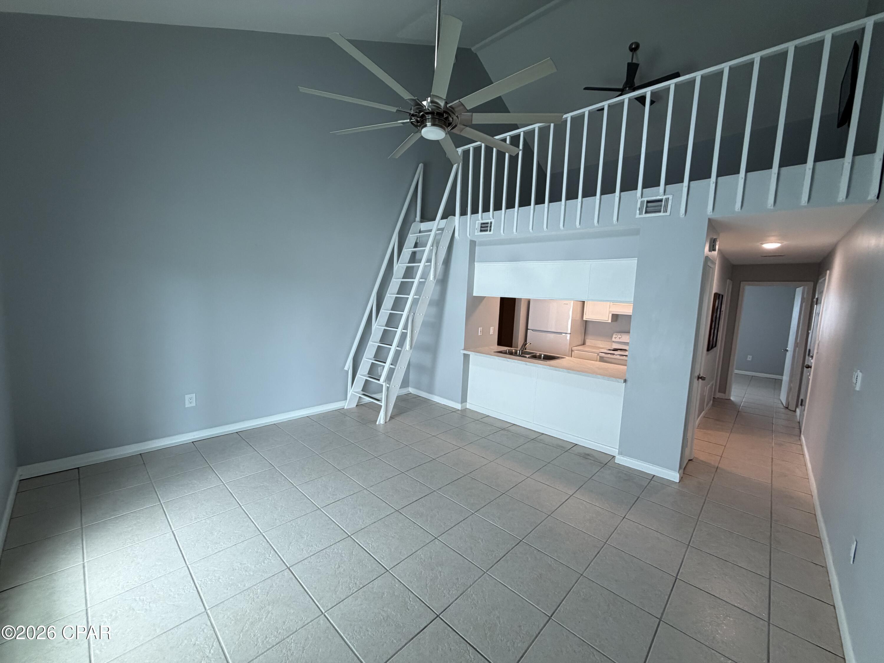 Welcome to Treasure Cove Condominiums on beautiful Grand Lagoon! Professional Pictures Coming Soon.  OWNER IS OFFERING 10,000 Furniture credit to be able to make it your own slice of Paradise. Also, Owner is willing to trade for a single-family home of equal value. This spacious 1-bedroom, 1-bath condo with a loft offers approximately 980 square feet of coastal living in one of Panama City Beach's most desirable waterfront communities. Located on the third floor, this well-maintained unit features soaring ceilings, an open-concept living area, updated finishes, and a private balcony perfect for enjoying lagoon views and Gulf Coast breezes. Featuring Washer and Dryer Hookups for added convenience  Recent improvements include updated bathroom fixtures, kitchen countertops, lighting, ceiling fans, flooring, and sliding glass doors. The versatile loft provides additional sleeping space, a home office, or recreation area. Treasure Cove amenities include a lagoon-front pool, fishing dock, and boat dock access, with convenient proximity to marinas, restaurants, shopping, public beach access, and St. Andrews State Park. Whether you're seeking a primary residence, vacation getaway, or investment property, this turnkey condo offers an exceptional opportunity to enjoy the Panama City Beach lifestyle.