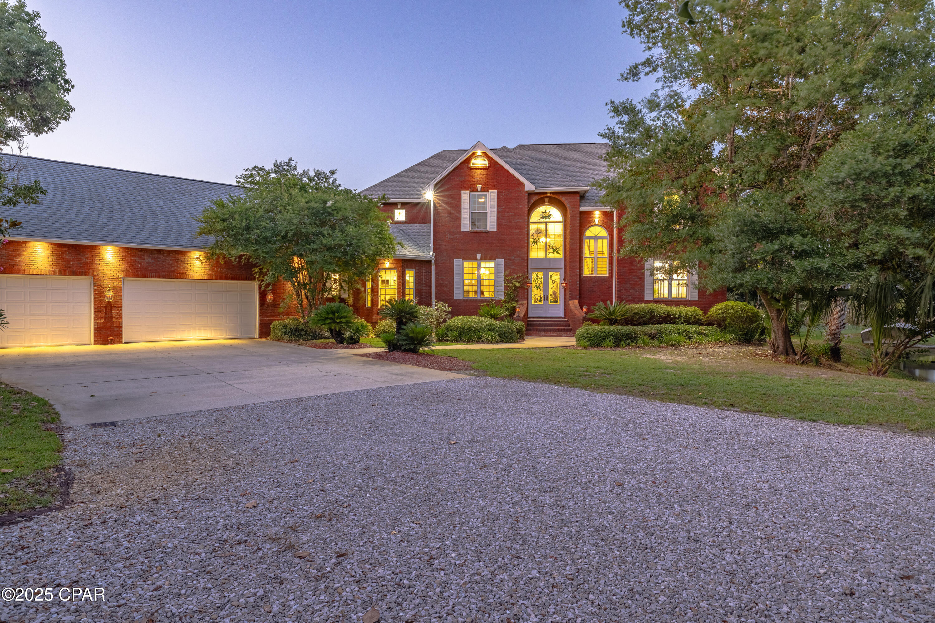 PRICE IMPROVEMENT!!! OWNER FINANCING AVAILABLE!! This beautiful 2 story WATERFRONT ESTATE has it all! Custom built in Lynn Haven, FL and tucked away on an oversized 2 acre corner lot in a very private setting and quiet neighborhood. Beautifully landscaped with a fish stocked pond, mature trees and an abundance of flowers with something blooming in all seasons. A boater's dream with deepwater access to North Bay and the Gulf from the newly replaced big dock with boat lift! 300 ft water front! Open floor plan on 5,500 sqft with 5 BR's and 5.5 baths. Downstairs you'll find the master bedroom and an additional bedroom with full bath and private entry to the pool area what is currently used as a media room and would make a perfect mother-in-law suite or office. Upstairs are 3 more bedrooms, each with own bathroom. The house has beautiful views of the bay and yard from various rooms. The chef's kitchen with all new appliances including double ovens, Viking warming drawer and gas stove top overlooks the fenced in pool area. Vaulted ceilings, stained glass windows/doors, custom made gas fireplace! The large recreation room upstairs overlooking the bay has a wet bar and leads to the sun deck. Three more bonus rooms upstairs totaling over 800 sq ft - use as a craft room, play room, office, man cave or fitness area. Walk-in 110 sq ft attic with endless storage! The oversized 3 + car garage is every car collector's dream! The house has solid brick exterior with thick walls and 2 x 6 framing. The roof is NEWLY replaced in 2023. The house has 2 NEW HVAC units, 3 NEW hot water heaters including 1 tankless water heater and 2 electric water heaters and NEW central vacuum, an oversized laundry room with extra storage, his and hers walk-in closets in the master bedroom, and a long circular driveway with extra parking. The pool has a new liner plus filter system and takes minimal maintenance. The fenced-in garden area is perfect for a small vegetable garden with raised beds already in place and includes a garden shed. The huge boat dock is BRAND NEW 2024 replaced with high end composite decking and has an outdoor shower and a fish cleaning station. All windows, most doors and floors are new as well. Irrigation in the whole yard. There is a custom made treehouse with a zip line. Too many amenities to list. OWNER FINANCING AVAILABLE!!! Call for your showing today!
