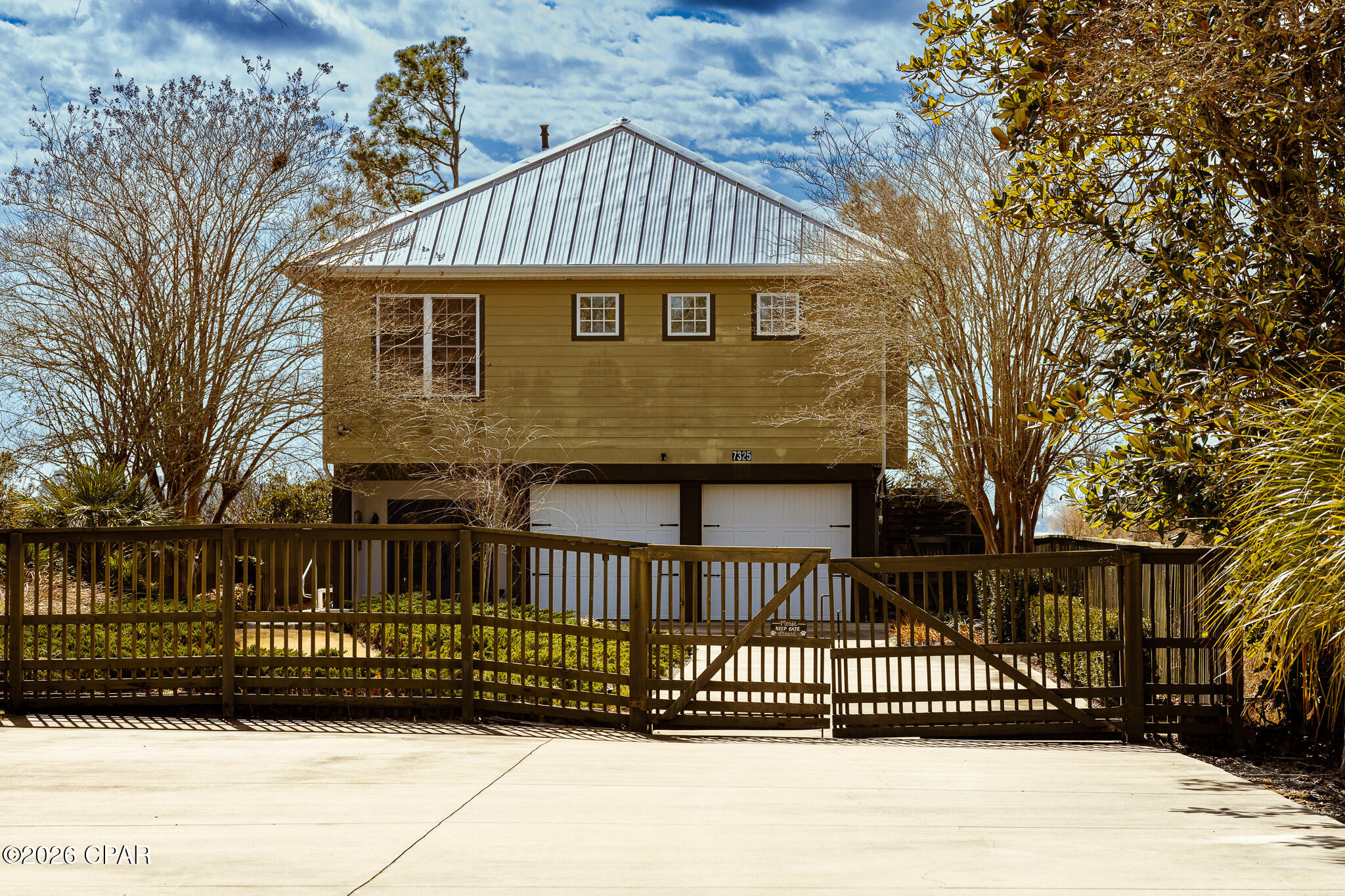 Custom-built in 2004 on 9′ pilings with 4′ of fill, this 2,172 sq ft, 3-bed, 2.5-bath home sits on the southeast corner of Fanning Oaks Peninsula with 50′ of frontage on Fanning Bayou/North Bay. Hardie board siding, 2020 metal roof, 2023 gutters, Rinnai tankless water heater, updated septic, and HVAC replaced in 2020. Open living with LVP flooring, built-ins, and bay views from every angle. Kitchen includes gas range, downdraft oven, double sinks, beverage fridge, under-counter fridge drawers, ice machine, pantry, and built-in hutch. Primary suite has dual baths, walk-ins, and office space. Extras include chair lift, dumbwaiter, screened porch, open deck, heated lap pool, and private dock with Gulf access. Lot is 0.47 acres, landscaped, fenced, and gated. Flood insurance approx. $990/yr. Assumable mortgage available.