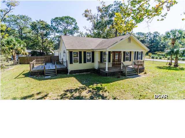 THIS HOME FEELS BRAND NEW! Built in 2007 and only used a few times a year, it is in immaculate condition. Owners built with energy efficiency in mind. It has an energy efficient HWH, 18-SEER AC unit and spray foam insulation. There is tile in all 3 baths/kitchen/dining and wood in the living areas. The Master has recessed lighting and step up ceilings. The Master Bath features a double vanity and a Jacuzzi tub (only used once!). To top it all off...it sits on a large, corner lot that is entirely fenced. There is a side gate to a newly built 3 CAR GARAGE! IMAGINE THE POSSIBILITIES! The owner's have enjoyed spending their weekends relaxing on the front porch and side deck and enjoying what downtown Lynn Haven has to offer. The community park is right across the street. Walk to the
