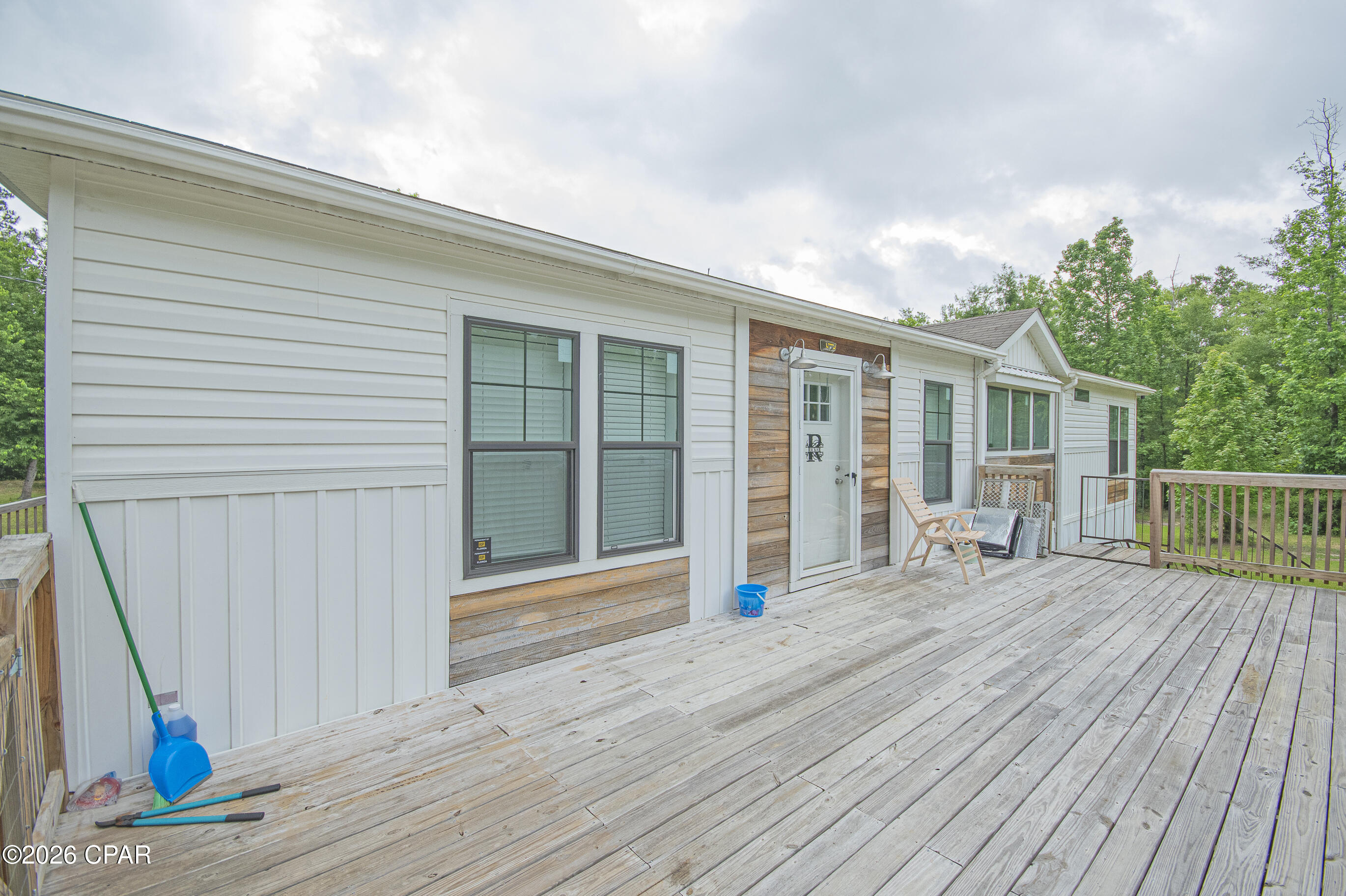 Welcome to your private slice of country living at 2504 Mildred Ln in Marianna! Nestled on 3.71 beautiful wooded acres, this 2021 Clayton-built home offers the perfect combination of modern comfort and peaceful privacy. Featuring 3 spacious bedrooms, 2 full bathrooms, and 1,830 square feet of thoughtfully designed living space, this home boasts an open-concept floor plan ideal for entertaining and everyday living. Step inside to oversized living areas filled with natural light, a spacious kitchen that flows seamlessly into the main living space, and a desirable split-bedroom layout offering privacy for the primary suite. The large primary bedroom includes a generous ensuite bath, creating a relaxing retreat at the end of the day. Built with quality construction including 2x6 exterior walls and 2x8 floor joists, this home is designed for durability and efficiency. Another added bonus is having your own private well and septic.  Enjoy the outdoors from on the front and back decks, surrounded by mature trees and plenty of room to roam, garden, or simply enjoy the quiet setting. Conveniently located just minutes from I-10, shopping, dining, medical facilities, and schools, this property gives you the best of both worlds--secluded country living with easy access to town amenities. Schedule your private showing today and come experience all this property has to offer!