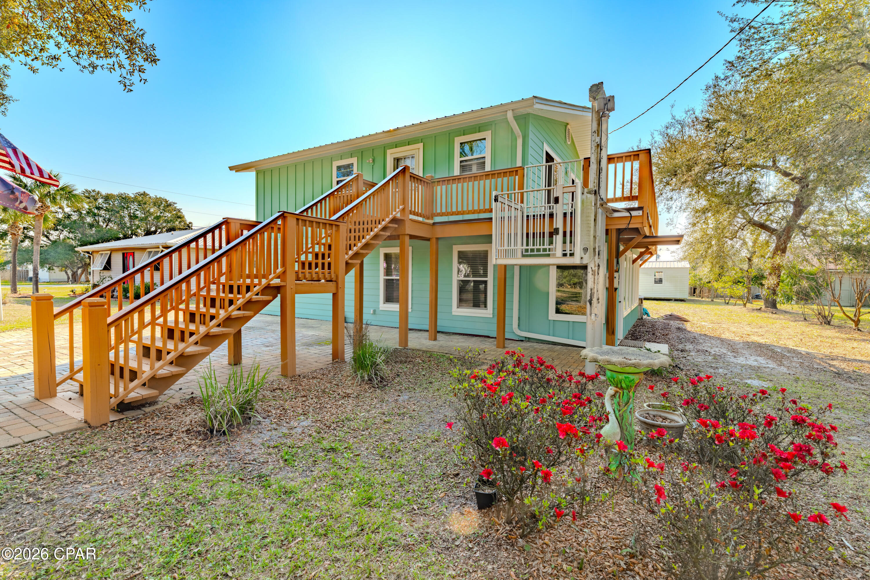 Discover the perfect blend of coastal living and income potential in this beautifully maintained home just steps from the beach in Port St. Joe!

This 2,048 sq ft heated and cooled property features two fully self-contained units, each offering 2 bedrooms, 1 bathroom, full kitchens, and spacious living areas--ideal for short-term rentals, long-term income, or multi-generational living. Live in one unit and rent the other, or maximize returns by renting both!

Situated less than two blocks (approximately 300 yards) from the beach, you'll enjoy quick and easy access via a dedicated beach access at the end of the street.

The downstairs unit includes a fully enclosed sunroom, perfect for relaxing year-round, while the upstairs boasts a spacious deck with beautiful views. Accessibility is a standout feature, with a $10,000+ exterior lift providing easy access to the upper level.

Recent updates and highlights include:

New roof (2019)
Durable Hardie board siding
Whole-home generator
Updated paver driveway and walkways
Two 12x20 metal storage sheds

Located just outside the flood zone (no flood insurance required)

The property is framed by stunning oak trees, giving it incredible curb appeal and a true coastal charm.

Whether you're searching for a primary residence, vacation home, or income-producing property, this one checks all the boxes.

Don't miss your opportunity to own a versatile beachside property with built-in income potential--schedule your showing today!