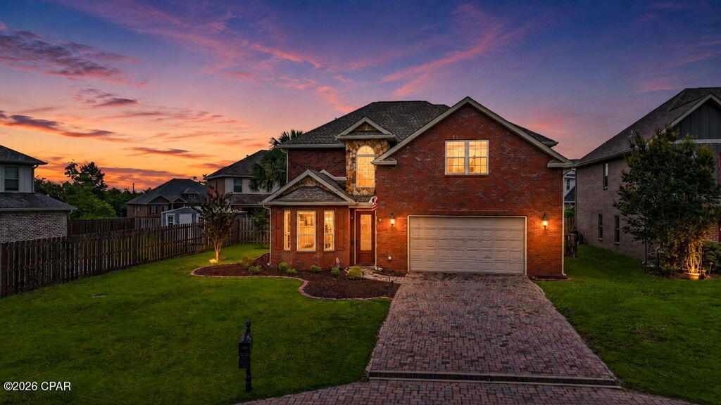 Welcome to 4910 Christy Lane, where comfort, quality craftsmanship, and exceptional outdoor living come together.

This beautifully maintained two-story brick home offers the perfect blend of elegance and functionality. Inside, you'll find soaring 10-foot ceilings, extensive crown molding, granite countertops, rich cherry cabinetry, and a stunning double-sided natural gas fireplace that creates a warm and inviting atmosphere throughout the main living areas.

The spacious primary suite serves as a private retreat, featuring its own balcony, dual vanities, a sunken soaking tub, and a walk-in tiled shower. Upstairs laundry adds convenience and practicality to everyday living.

Step outside and discover your own backyard oasis. Designed for both entertaining and relaxation, the outdoor space features a sparkling pool, fully equipped outdoor kitchen, paver patio, and mature landscaping that provides remarkable privacy year-round.

Additional highlights include a paver driveway, quality impact-resistant windows, sprinkler system, security system, and meticulous maintenance throughout. Conveniently located just minutes from Tyndall Air Force Base, shopping, dining, schools, and medical facilities.

Whether you're hosting friends and family or enjoying a quiet evening by the pool, this exceptional home offers the lifestyle you've been looking for. Schedule your private showing today.