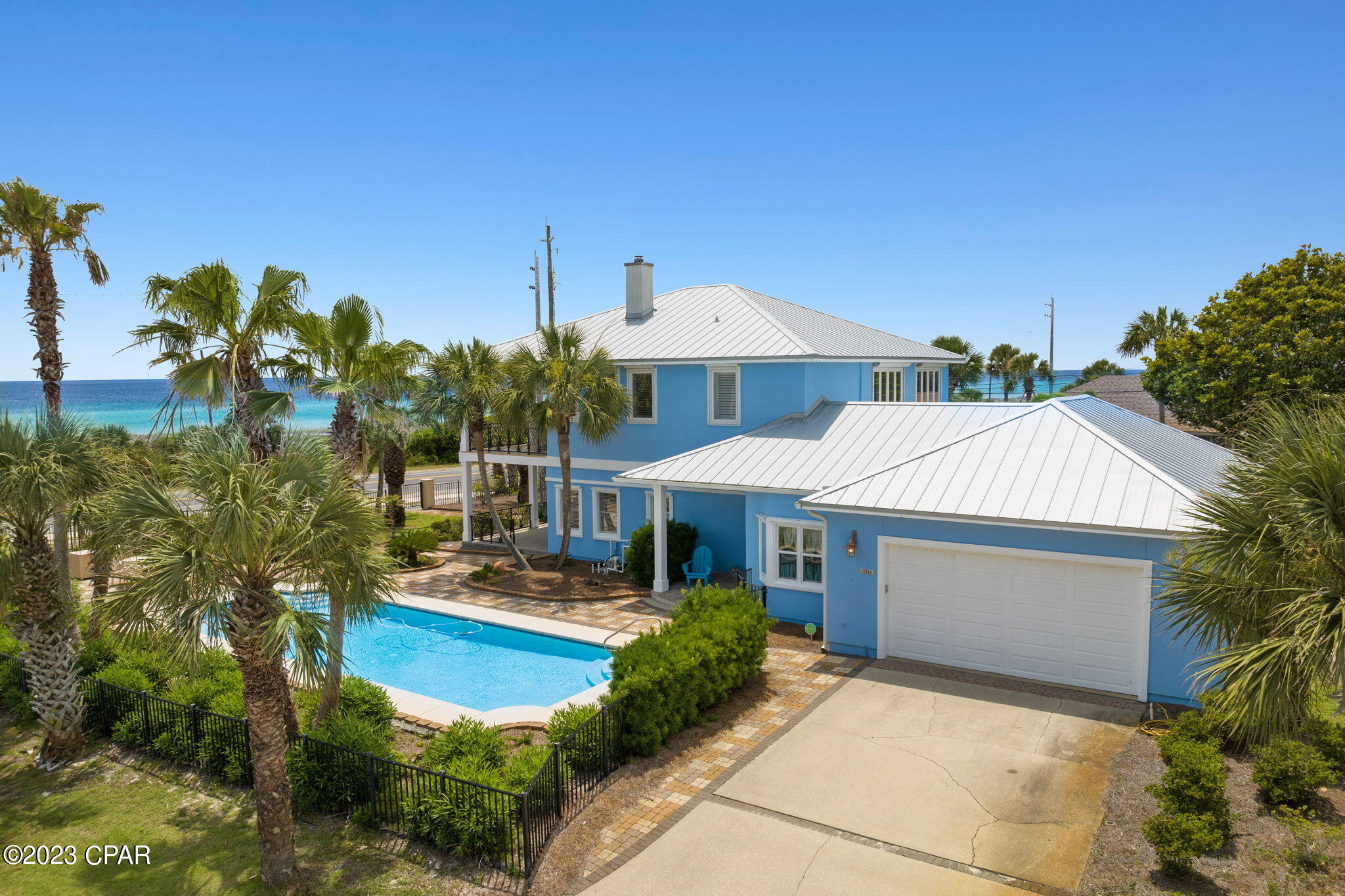 UNDER CONTRACT, SELLER WILL CONSIDER BACKUP OFFERS'  On an impressive corner lot with lovely palm trees and manicured grounds directly across from a private dedicated beach, this luxurious, 2-story home embraces the best of Old World and contemporary, glamour, comfort and upscale styling. The house is a testament to impeccable design and quality workmanship throughout. The sleek, modern kitchen, cozy breakfast nook and uncrowded first floor entertaining and living spaces are accented with pastel, coastal colors, exquisite trim, a wood-burning fireplace and finely-detailed ceilings. Attractive built-in bookcases in two downstairs rooms contribute to the versatility of having a bedroom, den and/or home office. The second story sports a mezzanine-style sitting area that opens to the upper level covered porch. Double French doors raise the bar on the master bedroom's entry where floor to ceiling windows flood the space with natural light and open to panoramic ocean views. A generous walk-in closet and superior tile and bathroom fixtures round out the master BR experience, and the other second story bedroom has its own bathroom. Outdoor covered porches beckon residents and guests alike to relax with awesome views to the horizon. The property is framed with black wrought iron which envelopes a lovely courtyard, patio areas, a inground pool, putting green and 4-car garage.
THE GROUND LEVEL WAS BUILT IN 1955 AND THE 2ND FLOOR WAS ADDED IN 2001. THE HOME WAS RENOVATED IN 2010. 

2 new AC units, new metal roof, exterior painted and 
the pool was drained and new gunite resurfacing to the pool all within the past 5 years. 

SURVEY NEEDED
It is the responsibility of the buyer to verify all measurements if important.