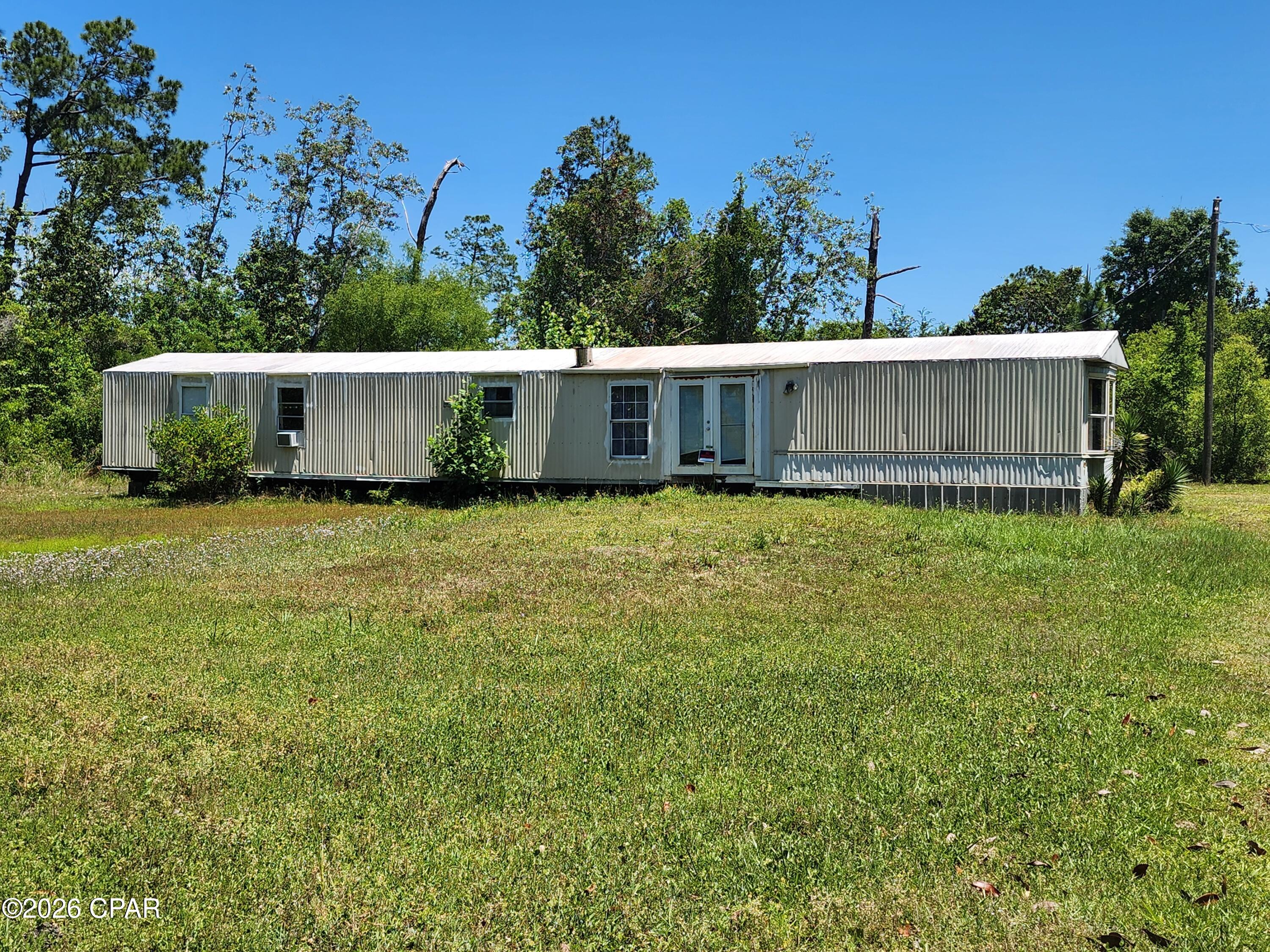 Spacious, private lot in Youngstown with a 2 bedroom manufactured home and a standout outbuilding. Set well back from the road and surrounded by mature trees, this property is all about the land and what you can do with it.
The highlight is a massive Quonset-style steel arch building with a concrete floor, ideal for equipment storage, a workshop, or RV and boat parking. A solid opportunity for an investor or buyer looking for land, storage, and room to grow.
Bring your vision. Properties with this much land and storage do not come along often in the area.