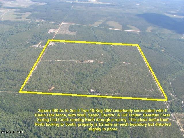 A 160 Acre Square 1/4 Section completely enclosed by 6' Chain Link Fence. Mostly flat land with scrub oaks and sandy soil. A pretty little Clear Creek runs from the South to the North in the middle of this property, and feeds a Pond on the Northern Boundary. Electricity is run to a couple of sites on this property, there are two Wells, and a Septic System in place. An older Mobile Home is at gate which has been vacant for several years, but appears to be habitable. Great opportunity to pick-up 160 acres for recreational property at a great price of approx $ 1,250 per acre. This property is in NorthWestern Calhoun County in NorthWest Florida, approx. 30 minutes South of Interstate 10 and approx. 45 minutes North of Panama City, Mexico Beach, or Port St Joe on the Beautiful Gulf of Mexico.