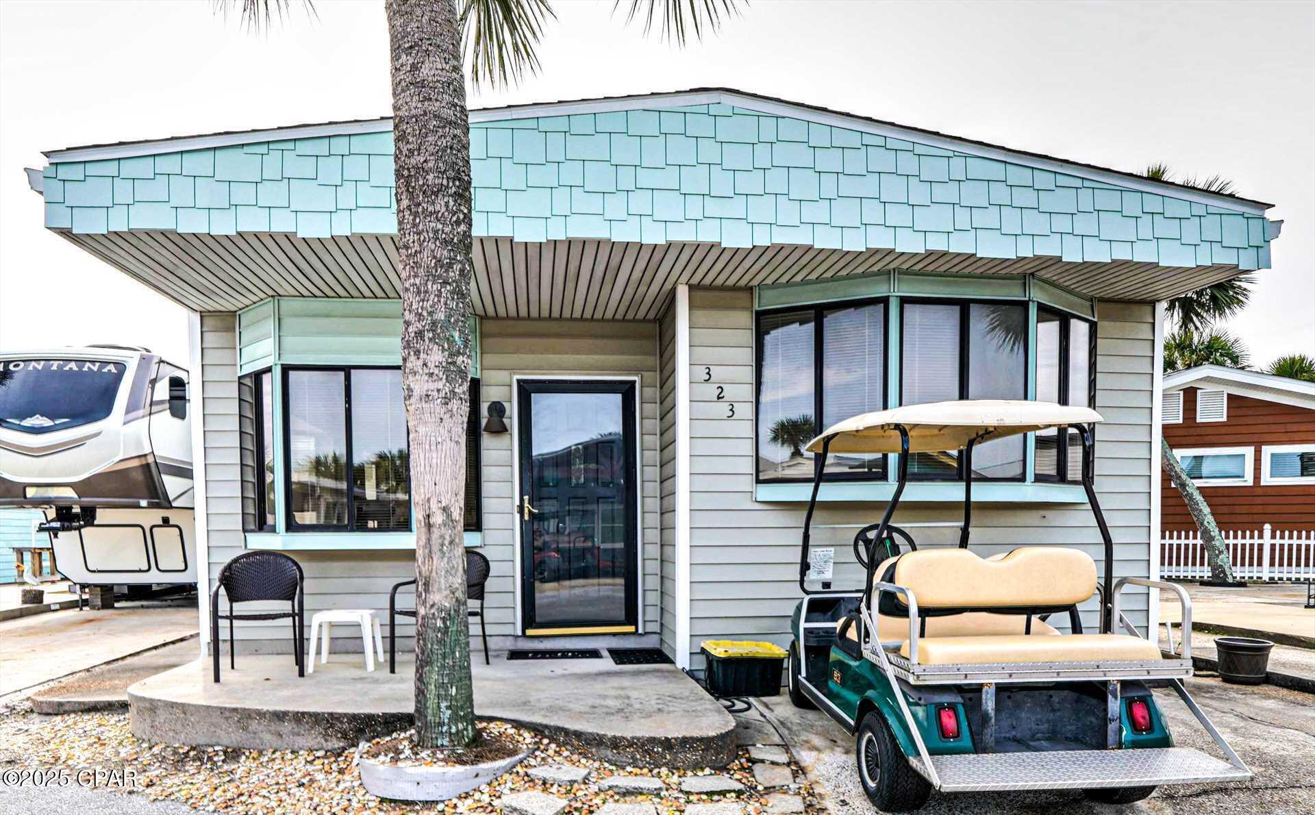 Check out this adorable 2-bedroom, 2 bath Venture Out home. Great floor plan and perfect location within the resort. Seller has recently added a new roof and gutters!  This home is being sold furnished and ready to go.   Nice screened in porch to relax on after a long day on the beach! Rentals on the books!  Seller may consider possible owner financing! Make this your 2nd home or use it as investment property, you're a winner either way!  Venture Out is a golf cart community that has exploded with popularity recently... With 300' on the beautiful pristine beaches of the Gulf of Mexico and 1,000' on the Grand Lagoon. Venture Out has something for everyone.