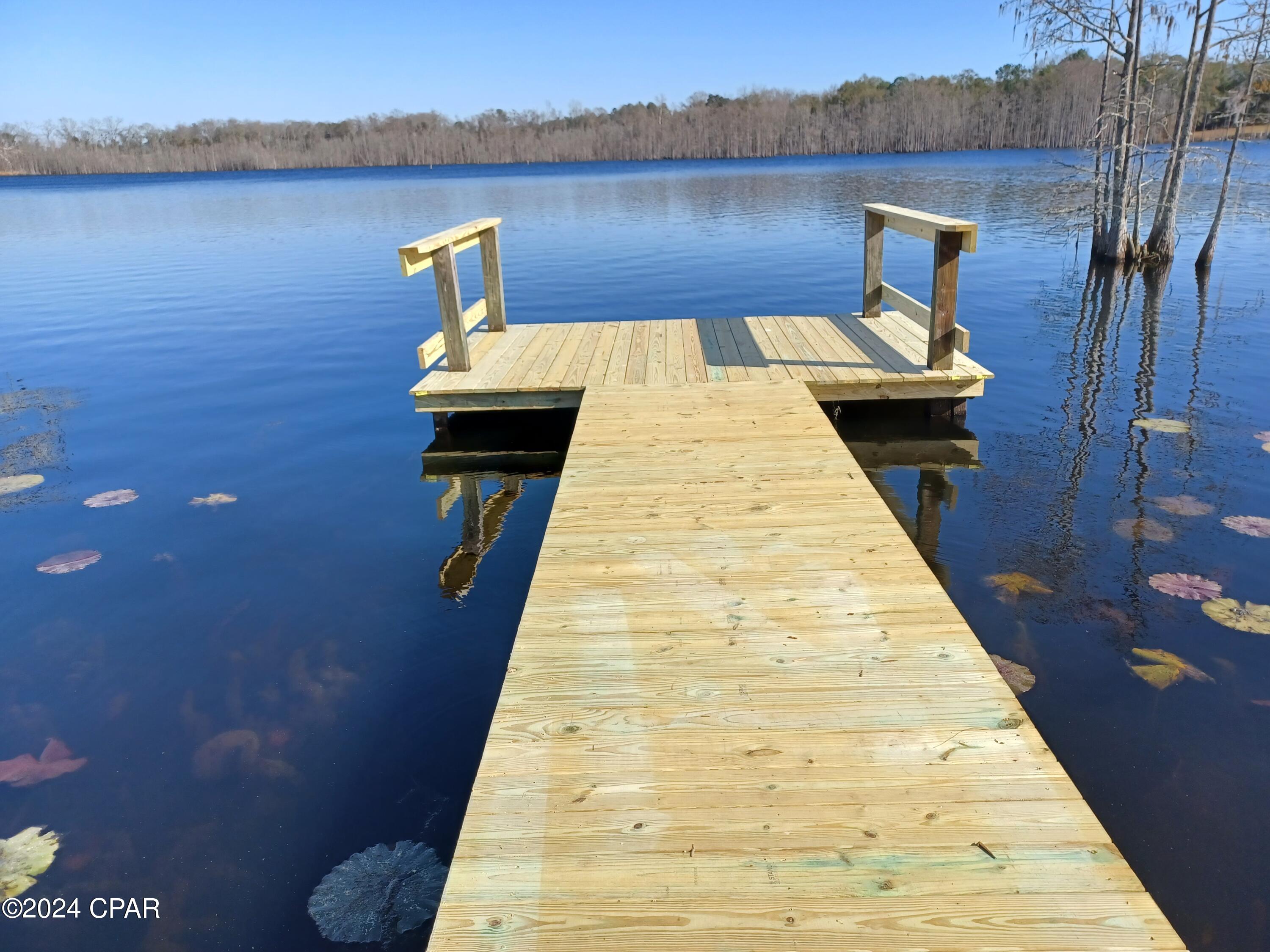 110 acres lakefront property, over 3800 feet of waterfront and 1400 feet of State Road 79 frontage. Residential and commercial possibilites. One hour from Panama City Beach. Approximately 80 acres upland. Sand Hammock Lake is approximately 175 acres and is spring fed.  A portion of the property was platted into 24 lots some years ago and is recorded in Holmes County. Property could be developed into a waterfront subdivision, an RV park, or kept as a private retreat with approximately 3800 feet of waterfront on Sand Hammock Lake. Existing  double wide trailer conveys, but is given no value.