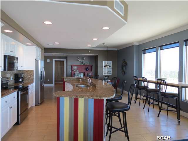 This 3-bedroom, 2-bath end unit enjoys commanding views of sunrises and sunsets from its 17th floor perch on the east side of Gulf Crest Resort Condominiums. Custom sunshades temper the light in the living areas and black out curtains in the bedrooms allow for late mornings when desired. Gulf Crest 1701 has been completely renovated from floor to ceiling and reflects today's modern design ethic. The current owners literally gutted the already stripped bank repo three years ago and installed an eclectic mix of modern and shabby chic decor and custom furnishings that will stay with the unit. The original textured swirl ceilings were scraped and refinished smooth. The carpet and builder grade tile were removed and new 12x24 sandstone porcelain tile installed throughout. Both bathrooms