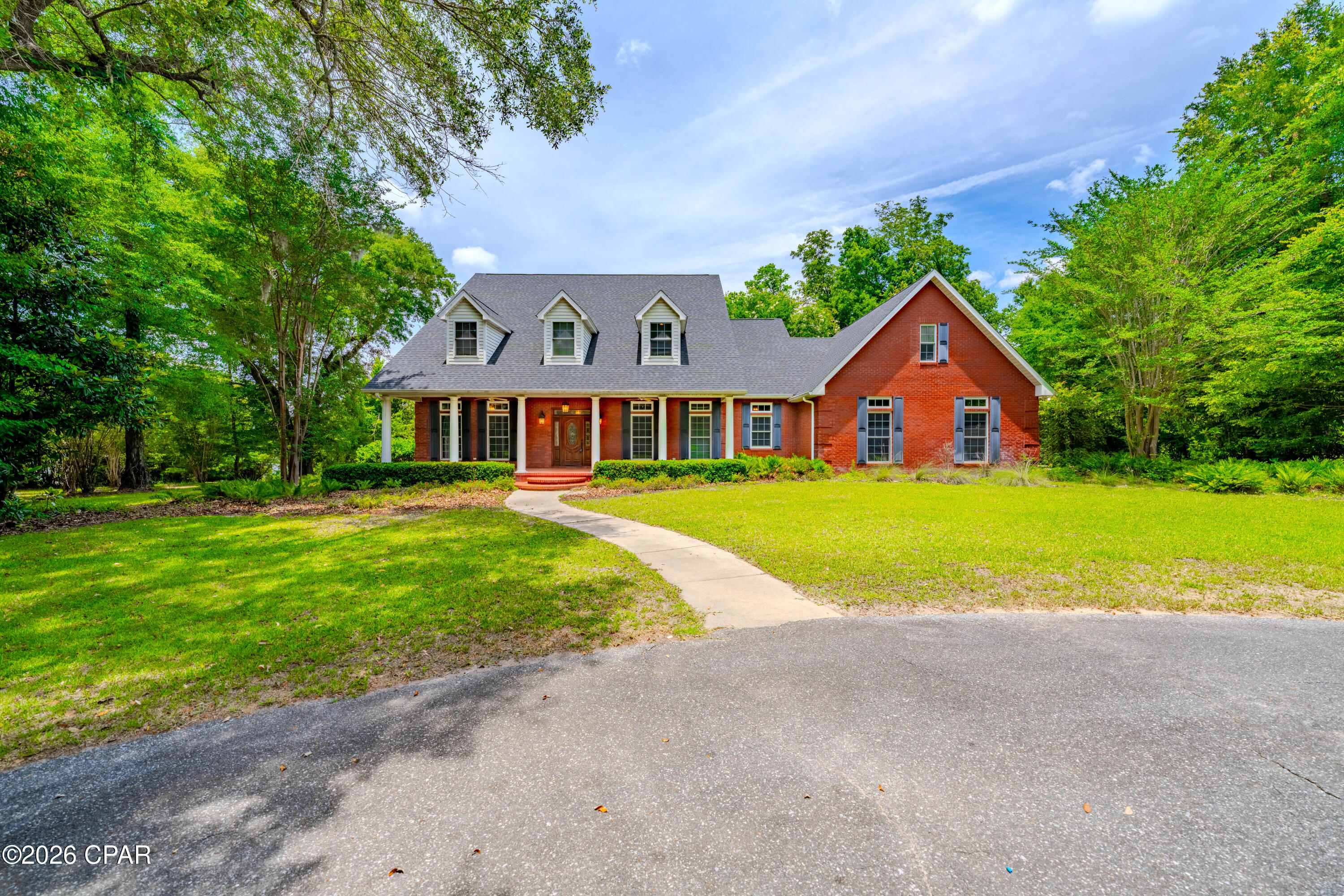 Welcome to this exceptional custom-built estate, perfectly positioned on what may be the most beautiful and private 4-acre homesite on Merritt's Mill Pond. Immaculately maintained and thoughtfully designed, this stunning waterfront property offers the perfect blend of luxury, comfort, and outdoor living.

Follow the gently rolling landscape down to your private dock, where crystal-clear, spring-fed waters invite you to spend your days fishing, kayaking, boating, swimming, or simply enjoying the breathtaking natural beauty that makes Merritt's Mill Pond one of Florida's hidden treasures.

Inside, this spacious 5-bedroom, 3.5-bath home with a dedicated office showcases quality craftsmanship and timeless design throughout. Elegant details such as coffered ceilings, crown molding, and custom built-in bookcases create a warm and refined atmosphere. The chef's kitchen is designed for both everyday living and entertaining, featuring a large center island, pantry, double ovens, gas cooktop, and stainless-steel appliances.

The generously sized first-floor primary suite offers a peaceful retreat with a luxurious en-suite bath and abundant closet space. A desirable split-bedroom floor plan places the additional four bedrooms upstairs, providing privacy and flexibility for family and guests. The open-concept living areas flow seamlessly throughout the home, while the dedicated office offers the perfect space for working remotely, studying, or managing daily tasks.

Step outside to enjoy the expansive covered porch, complete with a convenient gas hookup for grilling and outdoor entertaining. Overlooking lush green lawns that has its own underground irrigation system, this outdoor living space is ideal for relaxing with family and friends year-round.

Additional features include an attached two-car garage, ample driveway parking, and a setting that offers both privacy and convenience.

Rarely does an opportunity arise to own such a pristine waterfront estate on the crystal-clear, spring-fed waters of Merritt's Mill Pond. Schedule your private showing today and experience this extraordinary property for yourself.