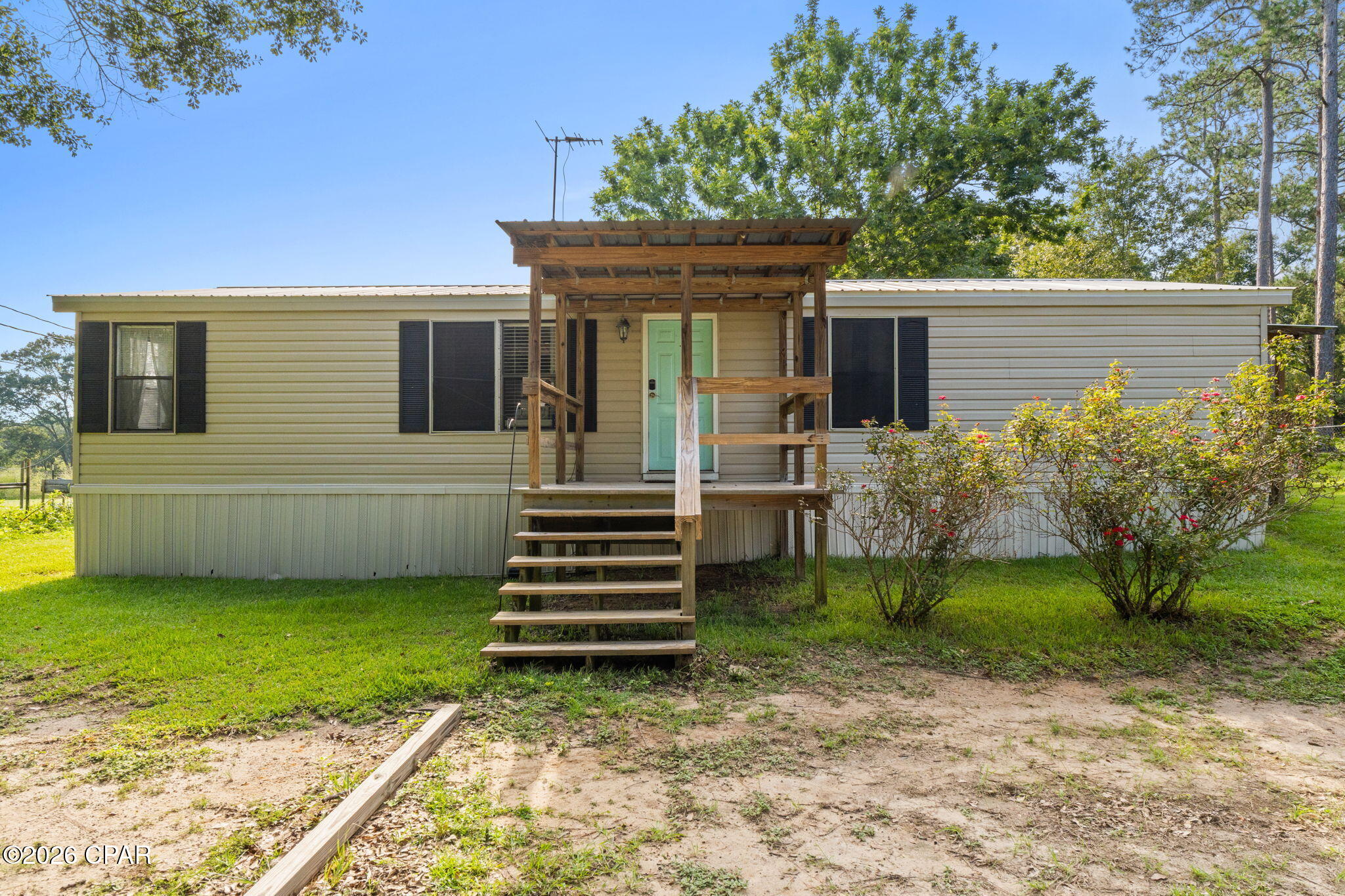 Discover the perfect blend of country living and everyday convenience with this manufactured home situated on 5 fully fenced and surveyed acres just outside of town. Ideal for a mini farm or hobby farm, this unrestricted property allows horses and farm animals and features two fenced pastures, a chicken coop, garden area, barn, tool shed, storage shed, and an impressive 36' x 44' pole barn. A separate electric meter services the tool shed, storage shed, and RV hookup.

Inside, the home offers warm farmhouse-inspired décor, a spacious primary ensuite with a walk-in closet, a gas range, and a breakfast bar. Recent improvements include new flooring, plumbing updates, and cosmetic updates. Relax and enjoy the peaceful surroundings from the covered front and side porches.

With shopping and schools nearby, this mini farm offers the acreage and rural lifestyle you have been wanting without sacrificing convenience.