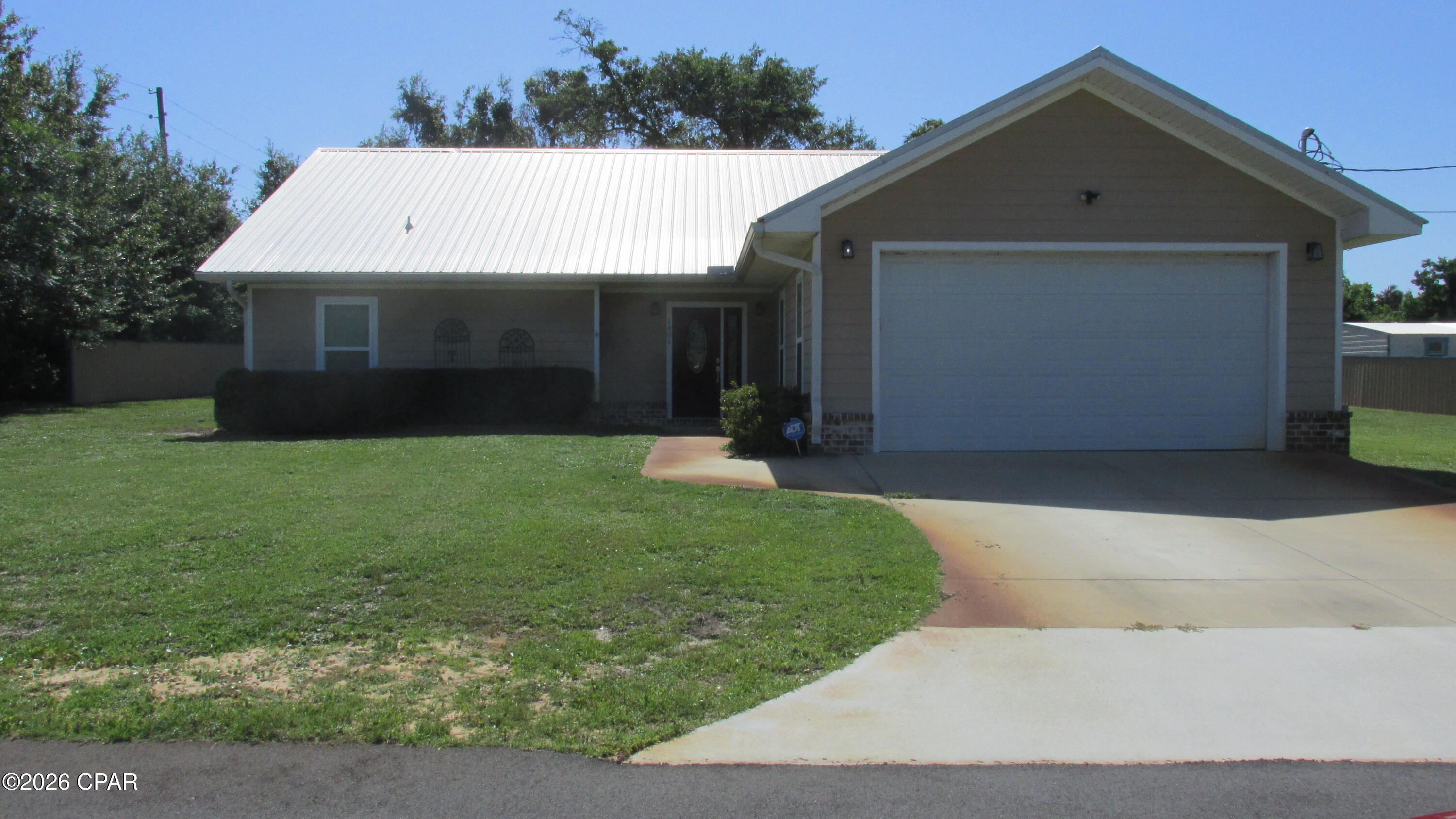 Like new starter home featuring an open floor plan with split bedroom concept. Kitchen equipped with stainless steel appliances including side by side refrigerator, ceramic cooktop stove, microwave, and dishwasher. Washer and dryer also convey with the sale. Features granite counter tops with an 8' breakfast bar. The master bath has a double vanity with granite countertop. Also features a large walk-in shower and oversized walk-in closet. Exterior amenities feature almost a half acre  of land mostly fenced with roofing metal to match house roof which is also a metal roof. Also features a sprinkler system with well pump.  The rear patio is huge and could easily be enclosed or screened. A storage room is adjacent to the patio and is equipped with a roll up door for easy access. The 2 car garage is equipped with an opener and pull down stairs for attic access.