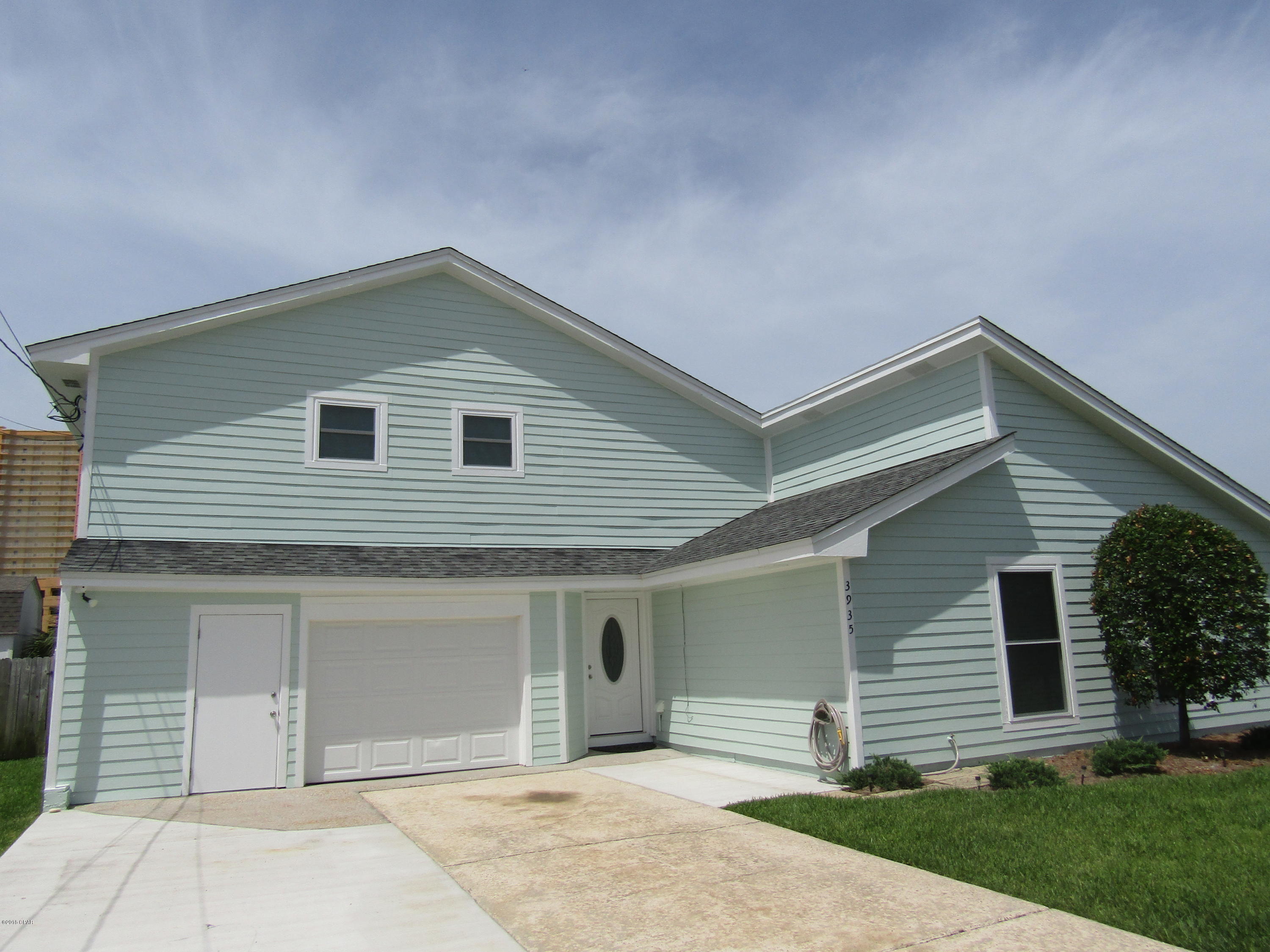 Beautifully remodeled 3 bedroom, 2 bath 2-story home located on the east end of Panama City Beach. Home features living room with fireplace, island kitchen with granite countertops and all new appliances, laundry, 2 bedrooms and bath on main, master suite upstairs exits to large balcony with a view. Home has garage with storage space, privacy fenced yard, large patio  and lush lawn with lawn service provided. Home is on septic system.