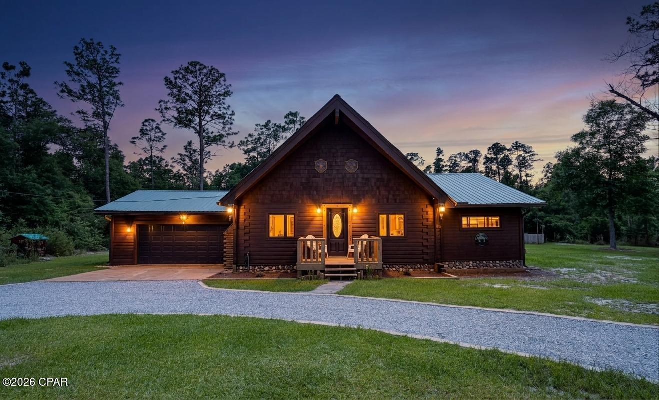 Escape to your own private mountain retreat in the rolling hills of Compass Lake, where rustic luxury meets timeless craftsmanship. This meticulously maintained, fully furnished custom cabin offers the warmth and charm of a Smoky Mountain lodge while being conveniently located just one hour from some of Florida's most pristine Gulf Coast beaches.

Built with exceptional attention to detail, this home features absolutely no sheetrock--every surface showcases the natural beauty of authentic log, cedar, and maple construction. From the moment you step inside, you'll be captivated by the soaring 24-foot cathedral ceilings that create an open, airy atmosphere while preserving the cozy ambiance only a true cabin can provide.

The thoughtfully curated interior is filled with meaningful and unique touches, including stunning Argentinian stone accents in the bathroom, hand-carved black bear statues, handwoven tapestries, and custom handcrafted furniture sourced from the mountains of Tennessee. Best of all, the home is being offered fully furnished, allowing the next owner to immediately enjoy the carefully selected décor and mountain-inspired furnishings. Luxury vinyl plank flooring runs throughout the home, complementing the rich natural wood finishes.

The spacious living area centers around a fireplace with a high-efficiency flame insert capable of heating the entire home, creating the perfect gathering space during cooler months. The kitchen is beautifully appointed with brand-new appliances, maple cabinetry, and ample storage. Deep closets throughout the home provide exceptional storage, while the loft offers flexible space for a home office, reading nook, or additional living area.

Step outside to the screened porch and relax as you take in peaceful views of nature. Situated on an approximately 3-acre corner lot (buyer to verify acreage with survey), the property features a charming turtle pond and a carefully designed circular gravel driveway lined with decorative block accents, creating an inviting entrance that perfectly complements the home's rustic character.

Major updates and investments provide peace of mind, including a brand-new HVAC system, new appliances, recently coated exterior logs, and a roof--all still covered under transferable warranties. The HVAC, roof, and exterior log coating remain under 10-year warranties, while the appliances are covered under 5-year warranties. The garage has also been recoated with durable Command Coating flooring.

Offering the perfect balance of privacy and convenience, this remarkable property is just 30 minutes from Marianna while providing a true cabin-living experience surrounded by nature. Whether you're seeking a full-time residence, vacation home, or investment opportunity, this one-of-a-kind retreat is truly a diamond in the rough.

A rare opportunity to own a fully furnished luxury cabin that combines craftsmanship, comfort, natural beauty, and modern peace of mind--all within easy reach of both town amenities and Florida's stunning beaches.