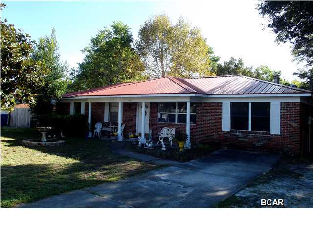 BRAND NEW METAL ROOF!! This Seller is Motivated! Great price for this updated home close to Tyndall AFB. The seller recently added Pergo flooring, replaced the bathroom vanities, toilets, shower and added tile. For more energy efficiency the seller had extra insulation blown into the attic, new thermal windows, and new water heater. There is a wood burning fireplace in the family room along with built-in shelves perfect for your personal library. Storage will never be an issue as not only is there lots of space and shelving in the utility room, there is a shed in the backyard. There is also a 24x12 workshop perfect for the handyman/craftsman and it does have power. The home is also under a termite repair bond. If you have kids and pets, you'll feel comfortable knowing they have a