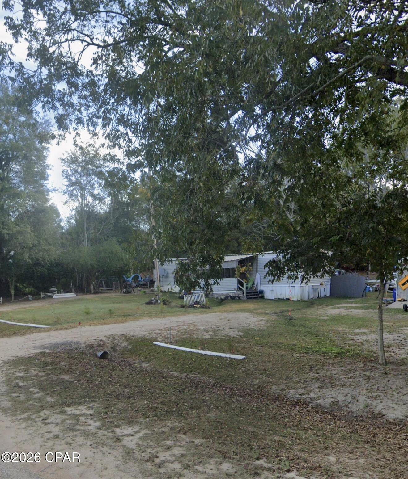 Situated on approximately half an acre across from beautiful rolling farmlands, this property offers a peaceful setting with plenty of potential. The existing mobile home it holds minimal value, making this an ideal opportunity for those looking for a land purchase, future homesite, investment property, or renovation project. Utilities are already in place, providing a head start for your vision. Enjoy the quiet country atmosphere while still being conveniently located near Bonifay and the FL/AL line. Property is being sold as-is and priced primarily for land value.
