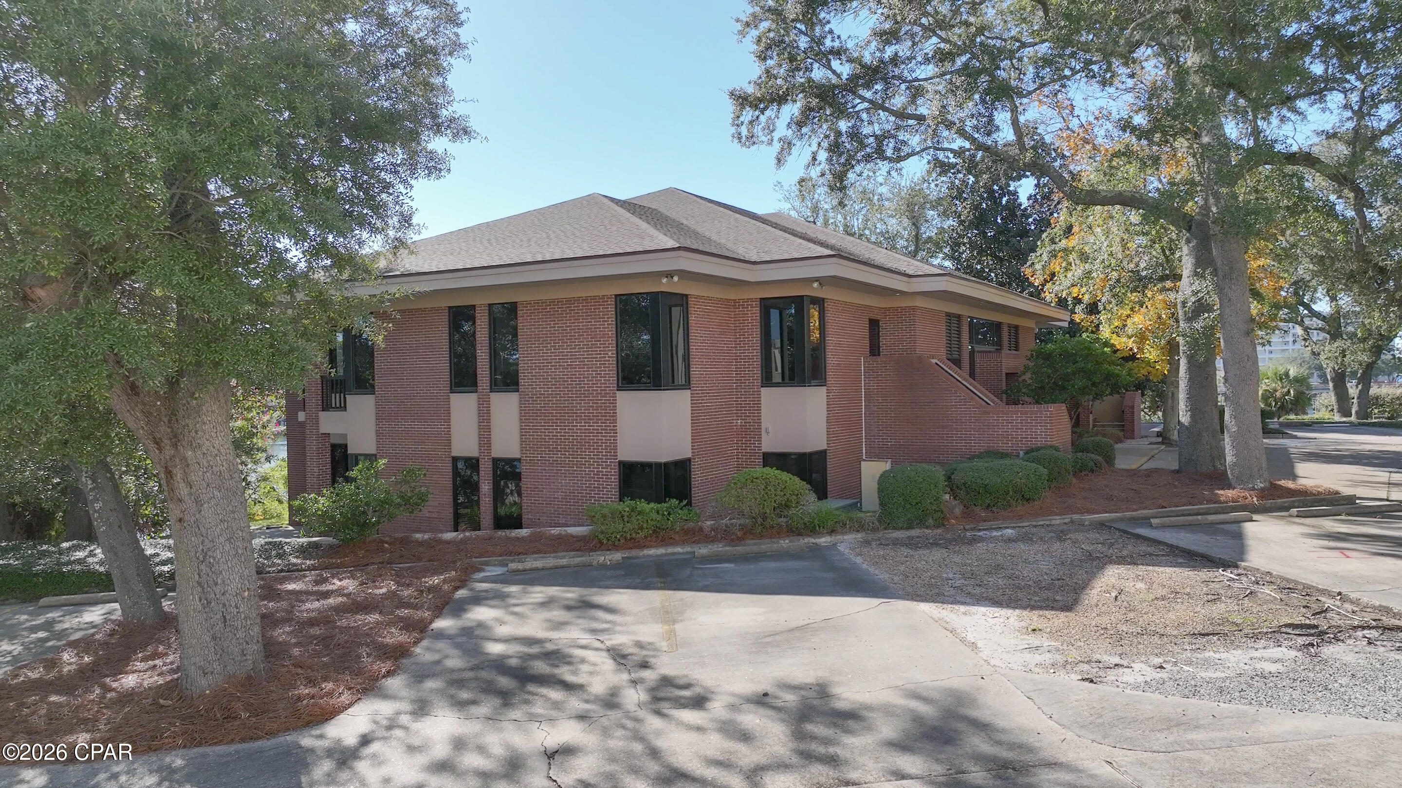 The Barron & Redding Law Office is available for lease. One of the most prestigious Class ''A'' law office buildings in Panama City. Located adjacent to the Bay County Courthouse on Massalina Bayou which leads directly to St. Andrew Bay and the Gulf of America. The 10,157 square foot, two-story office building is situated on 1.1 acres. Masonry construction with brick veneer and huge windows throughout. The entire office has extensive wood moldings, paneling, and trim, particularly in the attorney's offices, conference rooms, and law library. The two-story office includes 18 large private offices, 2 conference rooms, a law library, open office for paralegals and administration, workspace, large breakroom, and reception. Built in 1986 and renovated in 2019 following Hurricane Michael. The well-constructed building received minor damage from the Hurricane. The following renovations were completed: all new storm-rated impact windows and doors, new roof, new HVAC systems, and new flooring. There is +/-550 linear waterfront feet on Massalina Bayou with a submerged land lease in-place that provides for the deep-water dock space with a large pier and wooden dock capable of accommodating several large boats. Gorgeous views across Massalina Bayou. The Bay County Courthouse is less than 300' up McKenzie Avenue. Beautiful landscaping with mature oak trees all over the property. The location cannot be matched, and they truly do not make them like this anymore. The site plan, elevations, and floor plans are attached. Call for further details and to schedule a tour. Barron & Redding is merging with Hand Arendall.