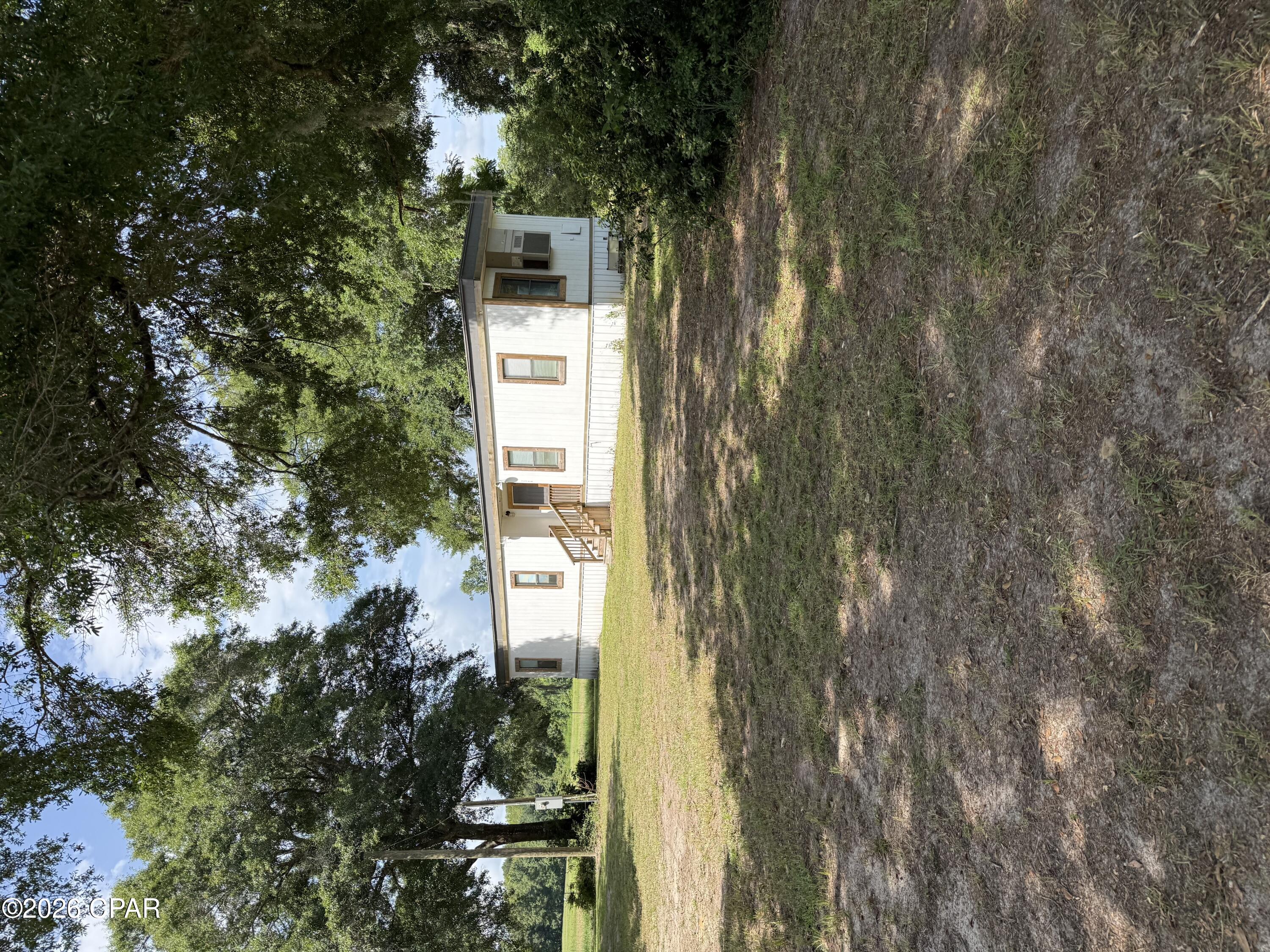 Two move-in ready small homes (mobile home and apartment style tiny home) on 2.19 acres! - 
The first home is an older model 1 bed/1bath, 664 sq. ft. single wide that has been renovated and updated with a rustic finishes, hard wood floors, wooden counter tops, and a wooden accent wall in the living room. The home is cooled with a single AC unit. Washer and dryer convey. 

The 2024 1 bedroom/ 1 bath tiny home/apartment (approx. 496 sq. ft.) sits directly behind the first mobile home behind a buffered tree/shrub line for privacy and  is cooled/heated with a single window unit. It has one main bedroom and two lofts for extra sleeping space as needed. It is also trimmed in rustic finishes. Washer and dryer convey. Both homes share a well but have their own septic tank.

The property has a fenced off area on the left side (approx. .86 acre pasture), with water if you would like to bring your horses or other livestock. 

These homes would be great rentals, primary residences for a multiple family situation, or even short term rentals for river enthusiasts, wildlife management hunters, and Florida natural springs explorers. 

Survey available per seller! Cash buyers preferred!