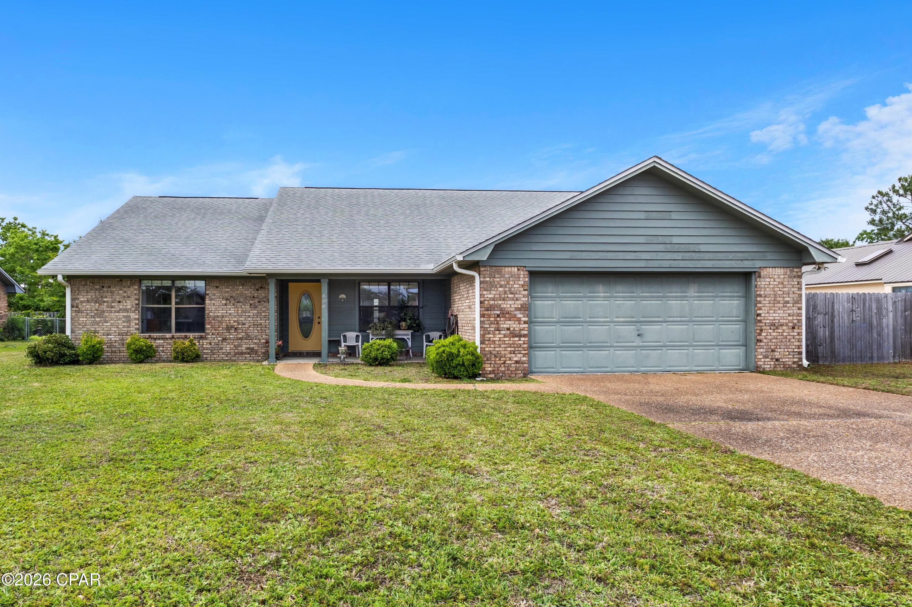 LOVELY BRICK HOME IN THE CANDLEWICK SUBDIVISION! This well-maintained 4-bedroom, 2-bath residence offers nearly 2,000 square feet of thoughtfully designed living space, featuring a split-bedroom layout and a semi-open floor plan that balances comfort and functionality.  The living room has a vaulted ceiling and a cozy fireplace with mantle and hearth, creating a warm and inviting focal point. Durable LVP flooring flows throughout the home. The kitchen is equipped with a pantry, elegant quartz countertops with a stylish backsplash, and a breakfast bar.  Enjoy both casual and formal dining with two separate dining areas. The oversized master suite includes a private bath with a jetted tub, double vanity, dedicated makeup vanity, separate shower, and a walk-in closet. The three additional bedrooms are good size and share a hall bath.  Exterior features include a charming covered front porch--perfect for seasonal decorations--a covered back porch, a privacy-fenced backyard, and a storage shed.  Located in the desirable Candlewick subdivision, the neighborhood offers sidewalks, underground utilities, and a welcoming environment ideal for walking and biking. Conveniently situated near quality schools, shopping, grocery stores, and everyday essential, this home is ready for you to see. Call today for a preview.  Measurements approximate.