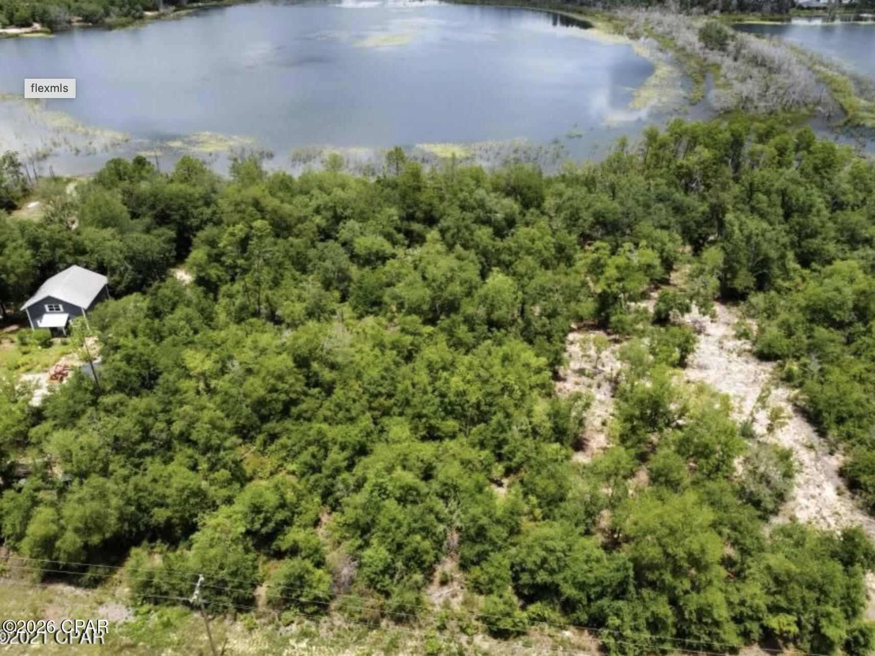 Check out this beautiful property! Lots 10 & 11 on Woodymarion Drive total approximately 0.90 acres in the Seminole Plantation area near the Sunny Hills subdivision in Chipley, Florida. The property is wooded and backs up to Spring Pond, providing a natural rear boundary. The lot remains uncleared, allowing flexibility for future home placement while preserving existing trees and natural vegetation. The rear boundary offers separation from neighboring properties and a natural backdrop. Located in a rural residential area, the property provides space and natural surroundings suitable for a custom homesite. Buyer to verify all measurements, zoning, building requirements, utilities, and restrictions.
Call a REALTOR today for a private tour.