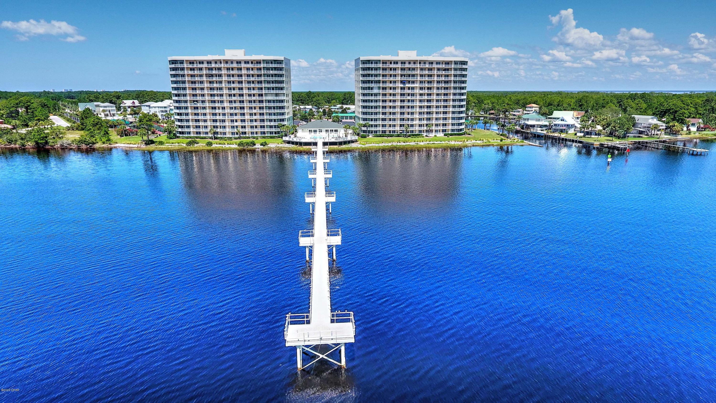 This luxurious condo is Bayfront and comes with three (3) bedrooms and a boat slip.  This Hibiscus unit has received a complete remodel.  The kitchen is re-designed and features an island and wine bar.  The windows provide a bright and airy space in this end unit.  Tastefully decorated and professionally painted. Wood-look tile planks provide the warmth of wood and durability of tile.  While all the bathrooms were updated, the master is truly something special.  The tub was taken completely out and replaced with the walk-in shower.  Cabinetry and granite are consistent throughout the unit.  The wrap-around balcony provides an exceptional view of the bay, inter-coastal, and harbor.   A garage is available to purchase if desired.  Over 2000, sq.ft. which provides abundant living space.