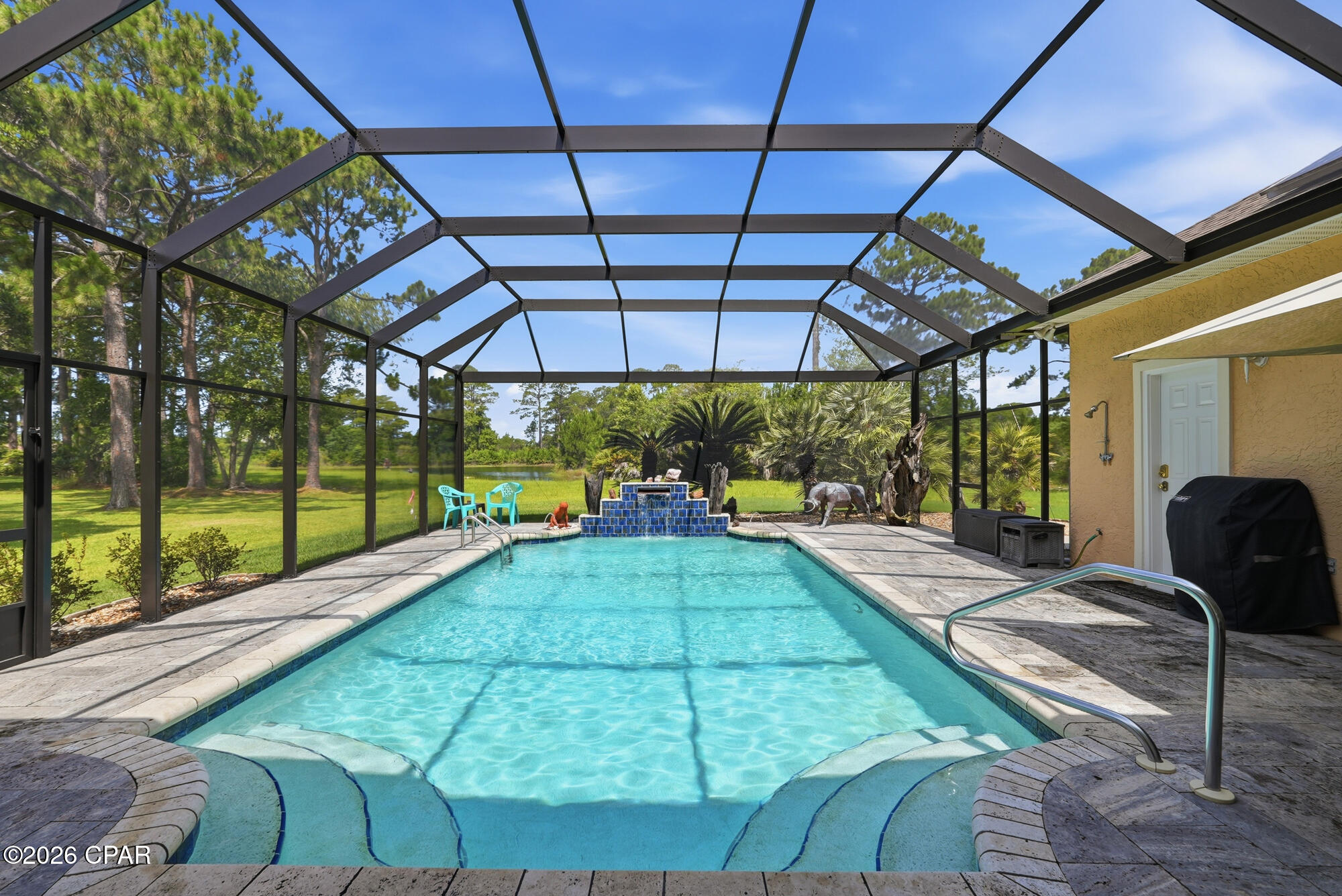 Custom Construction in THE GLADES, Panama City Beach, Florida...
Welcome to 152 Grand Heron Drive...an exceptional, custom-built residence which departs from the mass-produced, offering craftsmanship and architectural detail designed for secure and tranquil living, all with a large pool, Sundance Spa, idyllic water views -- AND all on ONE LEVEL. This COMFORTABLE home with its split bedroom floor plan showcases OPENNESS as soon as you enter the handsomely landscaped, large CIRCLE driveway. Step inside the beautiful leaded pattern-glass door and observe neutral porcelain tile throughout the home, a flowing floor plan that displays the elegance of high ceilings, crown molding, 2x6 construction, deep PLANTATION SHUTTERS, arched openings, and LOTS of LIGHT! HVAC is a 2023 Trane 4-ton and Trane 5-ton heater which is enough energy to heat and cool this large high ceiling home.  SOLAR PANELS accommodate half if not all the electrical cost. The Panels are on a Wi-Fi program aligned with internet that shows if any panel is not producing.                         
A new wind mitigation report showing hurricane improvements has led to significant insurance savings with a new insurance company. All standard exterior doors, French doors, garage doors, and windows are hurricane rated, are tinted, and are very durable...never have to be painted. The acrylic block bathroom windows all have hurricane rated panels that are easy to put up, and the beautiful stained glass and wood front door has hurricane rated fabric that is also easy to install. All outside doors have new Schlage locks with key and keypad access. The LARGE MAIN LIVING area includes a FIREPLACE, updated with a Dimplex electric insert and lighted, built in glass display shelves and storage cabinets. LARGE formal dining space flows into the living area with four large windows views to the pool. The PRIMARY suite showcases a seating area, two walk in closets, a large light-filled bathroom with separate vanities, and both a tub and spacious shower. Don't need a fourth bedroom? A generous area includes a LARGE, flexible-use room that might serve as an office for TWO and/or an area for hobbyist. The KITCHEN has BEAUTIFUL CABINETRY, wall oven, and an ISLAND that includes a PREP SINK. The security system SimpliSafe is a break into home alert system. which also has smoke detectors and water sensors under sinks and hot water tank detection system with 24-hour monitoring. The space flows to a breakfast area then into the FAMILY ROOM with easy access to the pool deck. The laundry area is large with lots of countertops and cabinet space, storage closets, and extra full-size refrigerator.  Now out to the LARGE, screen-enclosed pool accessible from three points in the home. The pool has Hayward equipment, and with its copper granules, chlorine use is minimal. The pool deck is laid with true travertine stone pavers. The November 2025-installed screen POOL ENCLOSURE with ''Clearview'' end screen enhances picturesque pond views, meets the city's 140 mile an hour wind requirement, and has the latest 17/20 polyester screen.  Rain gutters and a sprinkler system that includes adjustable bubblers are in place. The GARAGE has spaces for VEHICLES, golf cart, and/or work tables and equipment; pull-down stairs leads to floored storage above. This home and beautiful community with its LOW fees which includes trash pick up are within minutes of the Sugar Shore and Emerald Waters with three major access points, two at lighted intersections for safety and convenience. Shopping, fine & casual dining, entertainment, and medical facilities including a NEW branch of Tallahassee Memorial, are minutes away. All levels of school are nearby as is Gulf Coast College AND a branch of FSU. DUPLIN Winery and its LIVE MUSIC and beautiful gift shop is just a golf cart ride away!