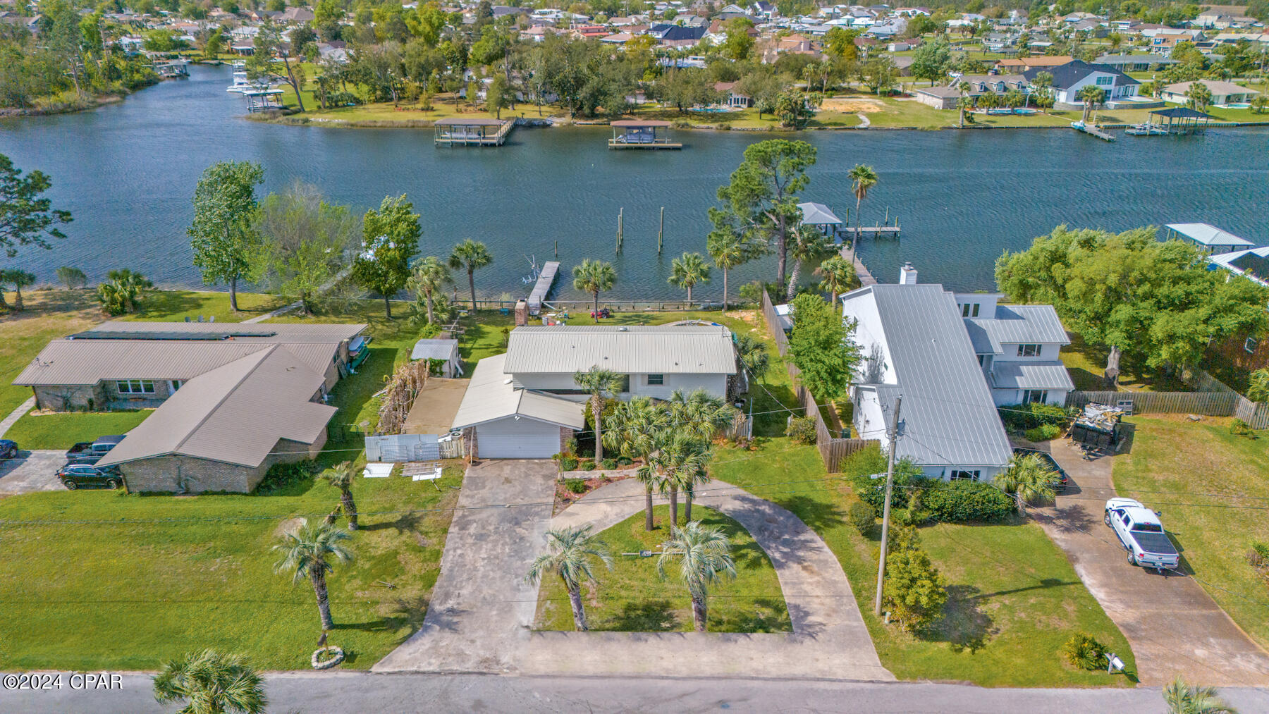 Introducing 705 Driftwood Drive, a stunning bayfront residence nestled in the coveted neighborhood of Northshore in Lynnhaven, Florida. This picturesque home offers amazing views of the bay and boasts coveted deep-water access, making it a haven for boating enthusiasts. The possibilities are endless in this home, awaiting your personal touch and vision to bring it to its full potential. The kitchen 
offers a blank canvas for you to design the culinary space of your dreams. Imagine whipping up gourmet meals while gazing out at the tranquil waters just beyond your doorstep. Throughout the home, there are ample opportunities for customization and modernization, allowing you to tailor each space to your unique taste and style. Whether you envision sleek hardwood floors, contemporary fixtures, or open-concept living areas, this home is ripe for transformation. Outside, the expansive lot with 100ft of waterfront, beckons with endless possibilities. Spend lazy afternoons lounging by the water's edge, make splashes in the inground pool or embark on aquatic adventures from your private dock. While this home requires updating, the potential to create your dream coastal retreat is limitless. Don't miss this rare opportunity to own a slice of paradise in Lynnhaven, where breathtaking sunsets and endless waterfront activities await.